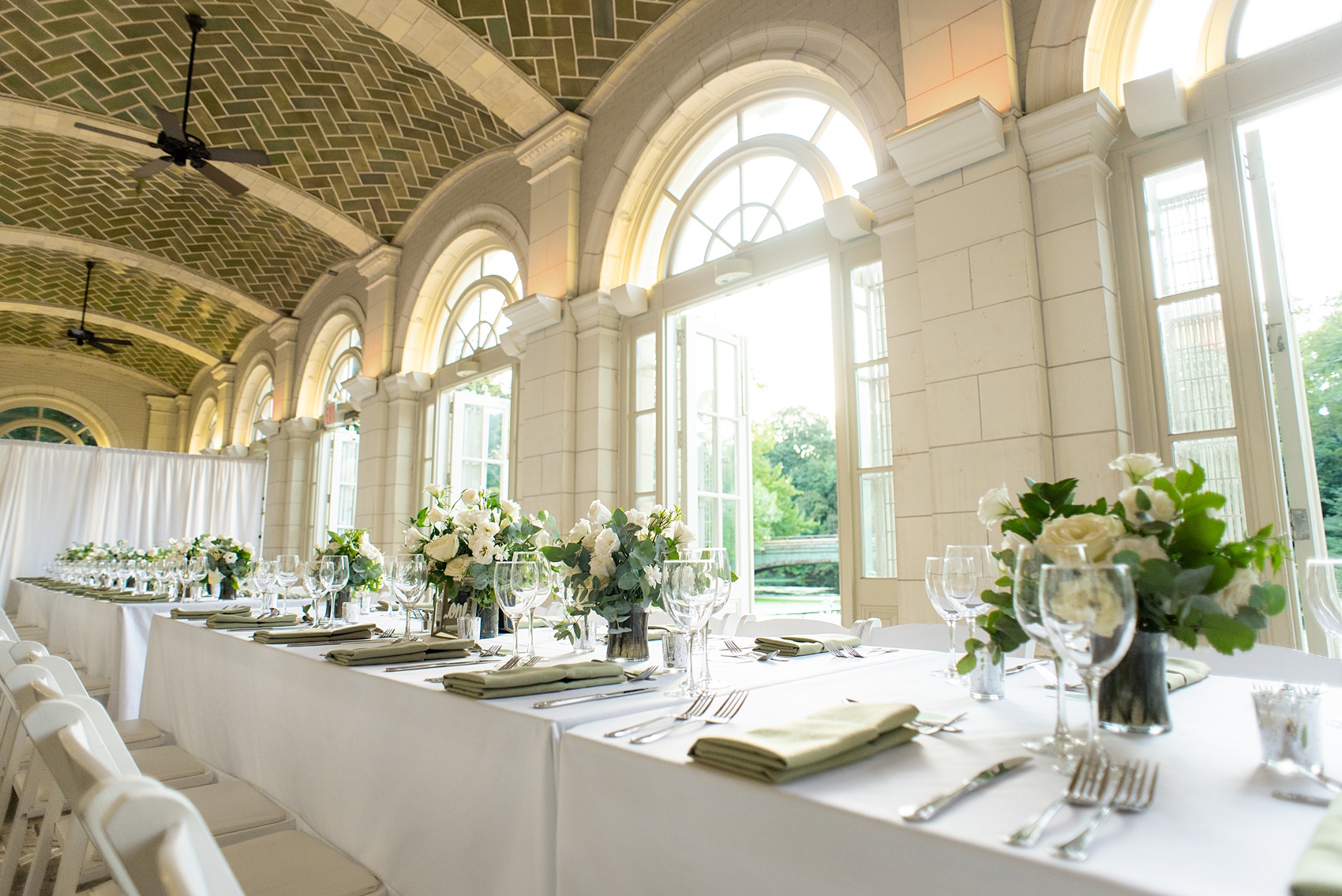 Prospect Park Boathouse wedding photos in Brooklyn, New York by Mikkel Paige Photography. This city wedding venue joins the indoors with the outdoors in a park setting with a historic New York City building. Photos include gay wedding decor inspiration and details with white flowers including dahlias, ranunculus, Veronica and Jasmine for a green and white palette. #mikkelpaige #prospectparkboathouse #brooklynwedding #brooklynweddingphotographer #whiteflowers #greenandwhitewedding #greenwedding