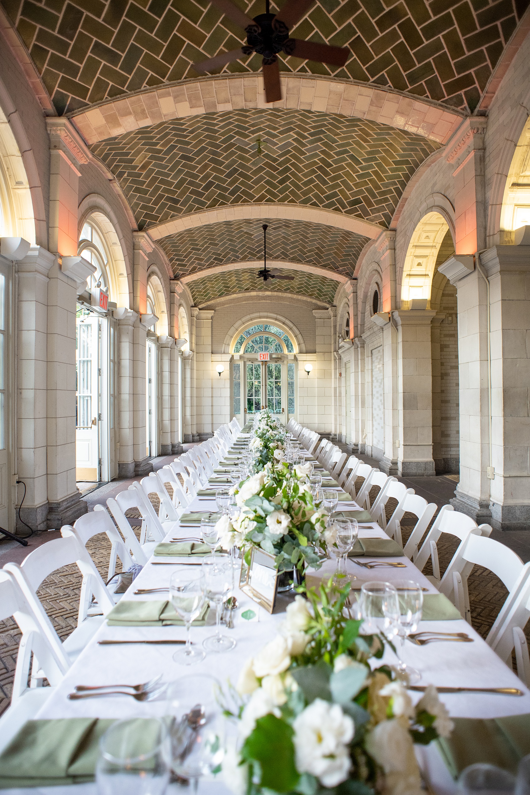 Prospect Park Boathouse wedding photos in Brooklyn, New York by Mikkel Paige Photography. This city wedding venue joins the indoors with the outdoors in a park setting with a historic New York City building. Photos include gay wedding decor inspiration and details with white flowers including dahlias, ranunculus, Veronica and Jasmine for a green and white palette. #mikkelpaige #prospectparkboathouse #brooklynwedding #brooklynweddingphotographer #whiteflowers #greenandwhitewedding #greenwedding