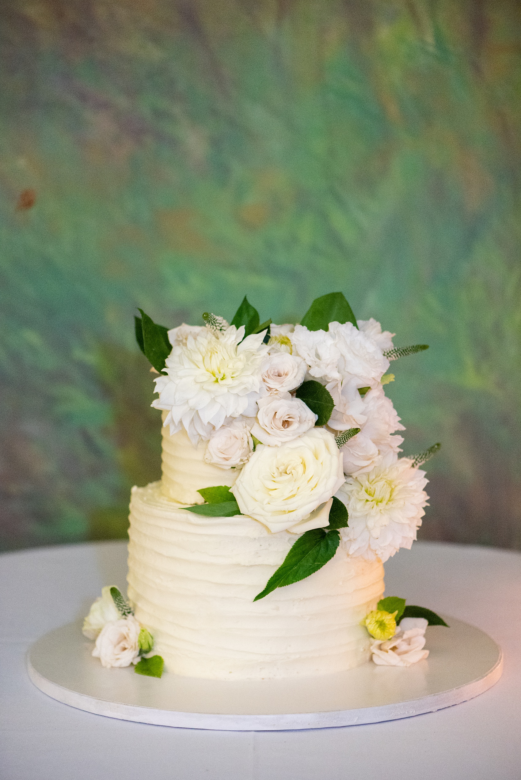 Prospect Park Boathouse wedding photos in Brooklyn, New York by Mikkel Paige Photography. Photos include gay wedding decor inspiration and details like their small buttercream cake. This city wedding venue joins the indoors with the outdoors in a park setting with a historic New York City building. #mikkelpaige #prospectparkboathouse #brooklynwedding #brooklynweddingphotographer #gayweddingideas #smallweddingcake