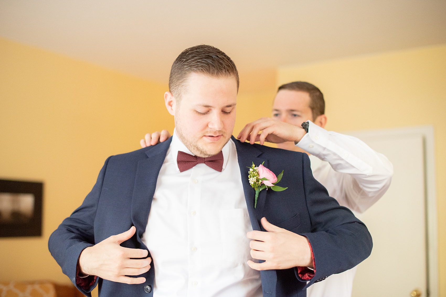 Getting ready wedding photos at Crabtree's Kittle House in Chappaqua, New York by Mikkel Paige Photography. This venue in Westchester county was the perfect place to capture the groom getting ready in a country setting, with his custom navy blue suit and Guinness socks! Click through for more fall wedding inspiration from their day! #bluesuit #mikkelpaige #CrabtreesKittleHouse #WestchesterWeddingVenues #WestchesterWedding #SeptemberWedding #gettingready #guinness #navysuits #customsuit #groom