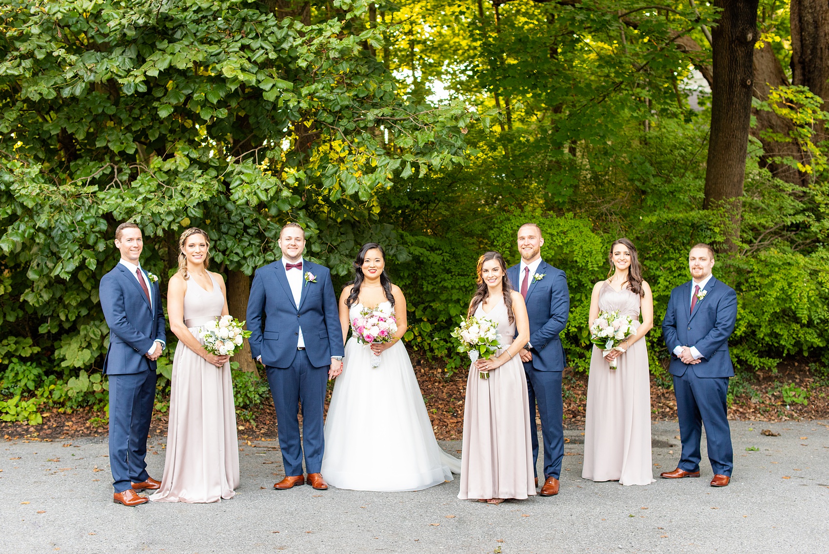 Wedding photos at Crabtree's Kittle House in Chappaqua, New York by Mikkel Paige Photography. This venue in Westchester county was the perfect place to capture their creative pictures, with the bridesmaids in dusty rose gowns & men in custom blue suits. The historic home is very close to NYC & has a country-like setting. Click through for more inspiration from their fall day! #bluesuit #mikkelpaige #CrabtreesKittleHouse #WestchesterWeddingVenues #weddingparty #bridalparty #vogueweddingphotos