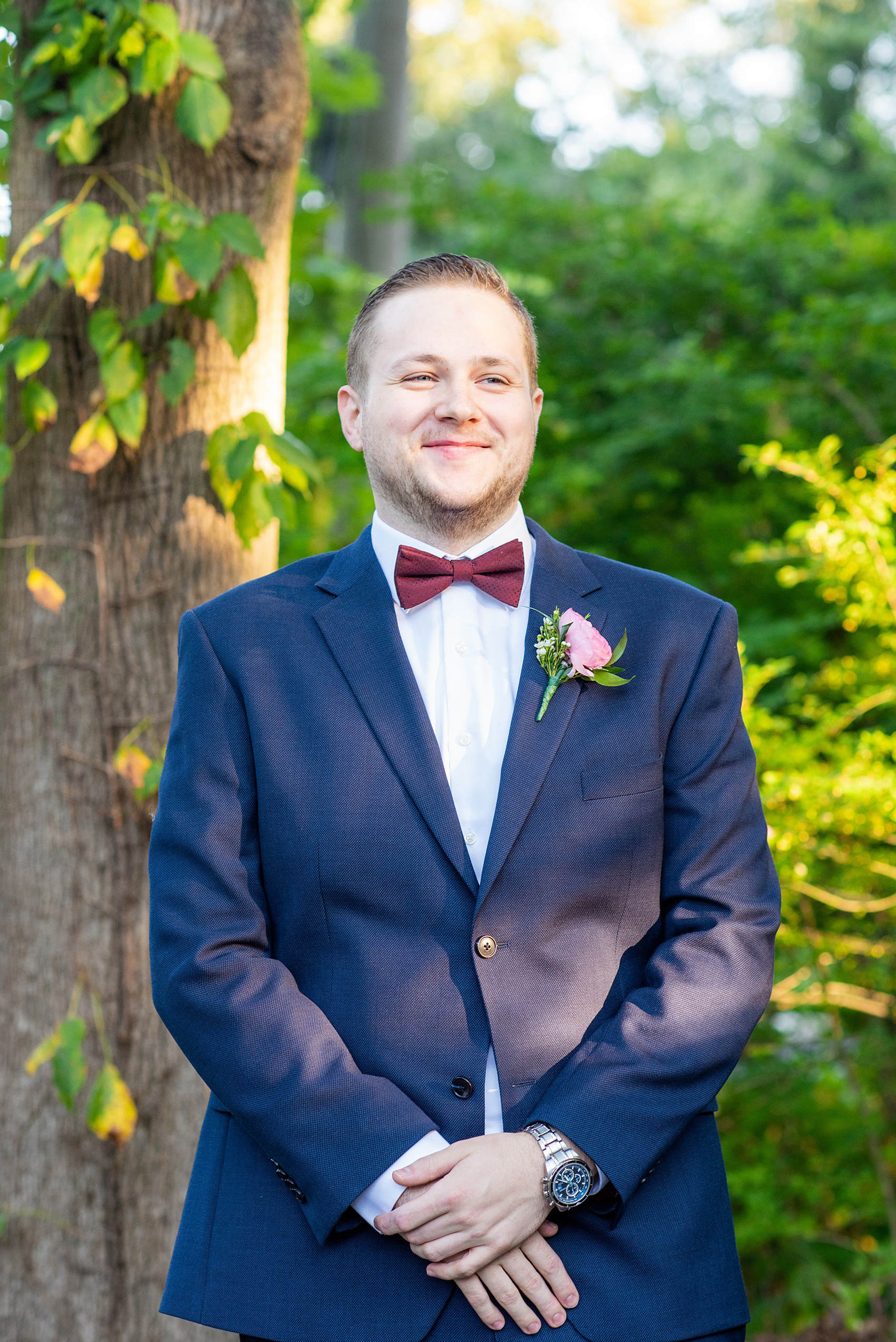 Wedding photos at Crabtree's Kittle House in Chappaqua, New York by Mikkel Paige Photography. This venue in Westchester county was the perfect place to capture the groom in a country setting, with his custom navy blue suit and and burgundy bow tie. Click through for more fall wedding inspiration! #bluesuit #mikkelpaige #CrabtreesKittleHouse #WestchesterWeddingVenues #WestchesterWedding #SeptemberWedding #navysuits #customsuit #groom #ranunculusboutonniere