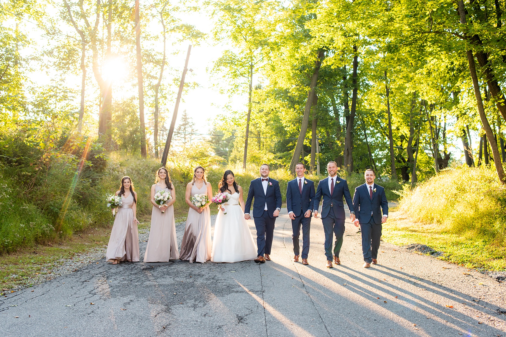 Wedding photos at Crabtree's Kittle House in Chappaqua, New York by Mikkel Paige Photography. This venue in Westchester county was the perfect place to capture their creative pictures, with the bridesmaids in dusty rose gowns & men in custom blue suits. The historic home is very close to NYC & has a country-like setting. Click through for more inspiration from their fall day! #bluesuit #mikkelpaige #CrabtreesKittleHouse #WestchesterWeddingVenues #weddingparty #bridalparty #vogueweddingphotos