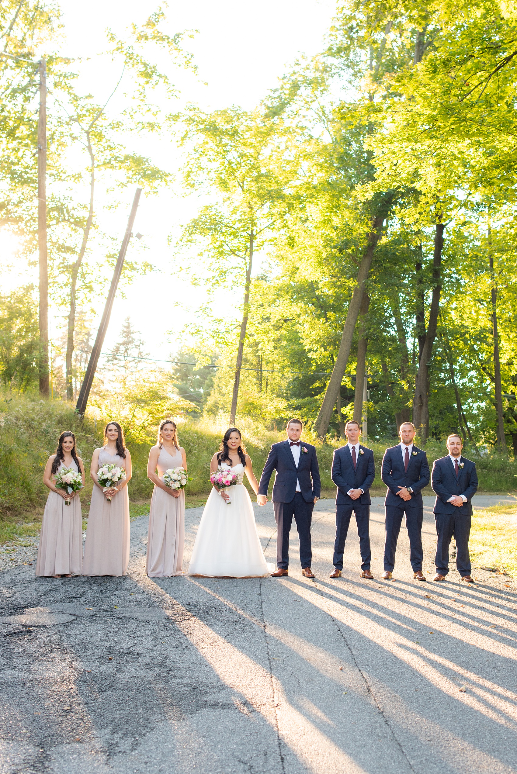 Wedding photos at Crabtree's Kittle House in Chappaqua, New York by Mikkel Paige Photography. This venue in Westchester county was the perfect place to capture their creative pictures, with the bridesmaids in dusty rose gowns & men in custom blue suits. The historic home is very close to NYC & has a country-like setting. Click through for more inspiration from their fall day! #bluesuit #mikkelpaige #CrabtreesKittleHouse #WestchesterWeddingVenues #weddingparty #bridalparty #vogueweddingphotos