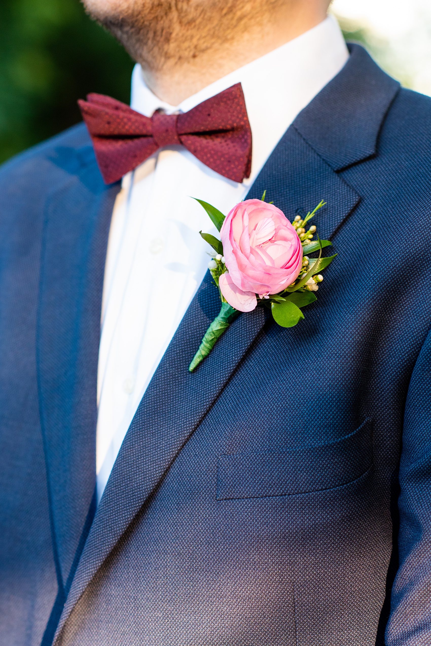 Wedding photos at Crabtree's Kittle House in Chappaqua, New York by Mikkel Paige Photography. This venue in Westchester county was the perfect place to capture the groom in a country setting, with his custom navy blue suit and and burgundy bow tie. Click through for more fall wedding inspiration! #bluesuit #mikkelpaige #CrabtreesKittleHouse #WestchesterWeddingVenues #WestchesterWedding #SeptemberWedding #navysuits #customsuit #groom #ranunculusboutonniere