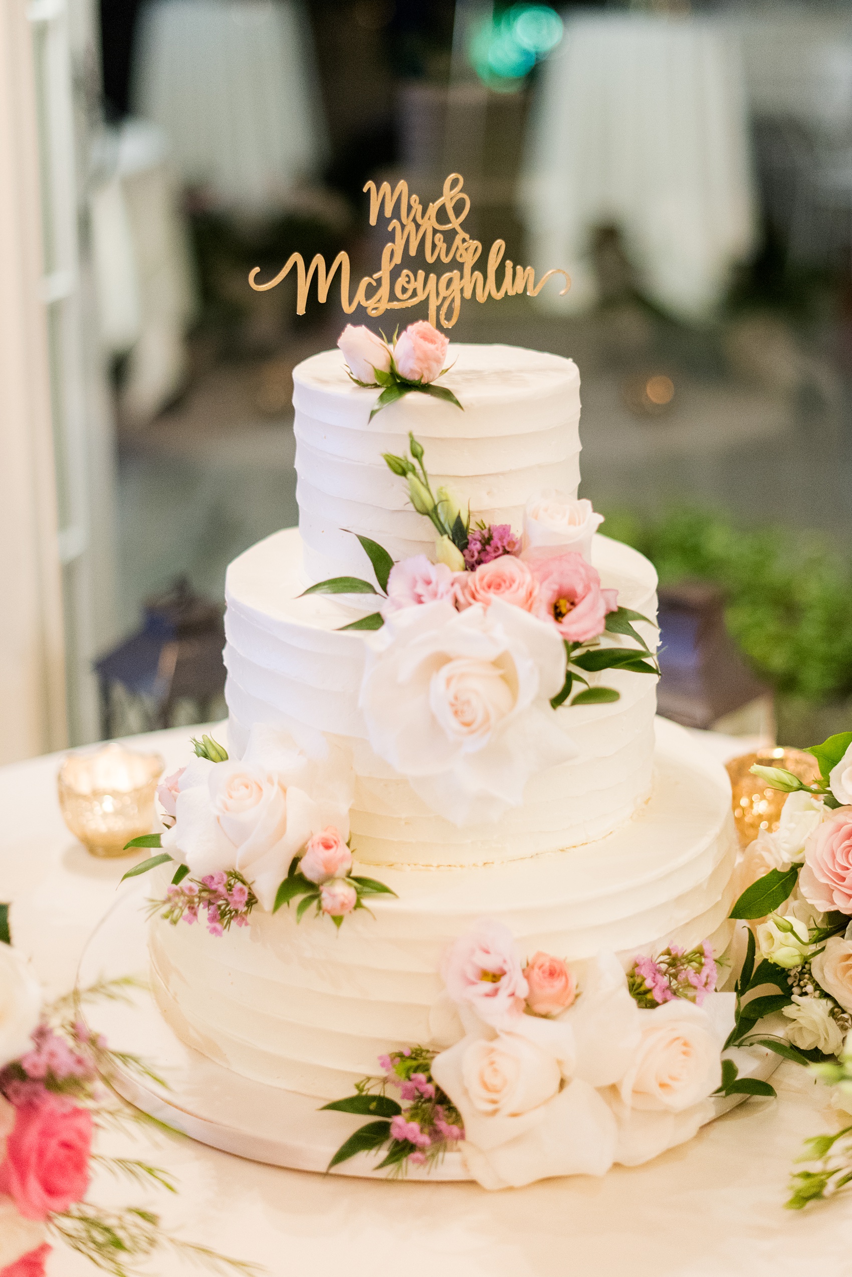 Wedding photos at Crabtree's Kittle House in Chappaqua, New York by Mikkel Paige Photography. The bride and groom had a beautiful three tiered, buttercream wedding cake covered in flowers with a gold cake topper with their name! Click through for more reception inspiration from this beautiful September wedding! #mikkelpaige #CrabtreesKittleHouse #WestchesterWeddingVenues #WestchesterWedding #summerwedding #weddingcupcakes #weddingcakesubstitute #ScriptCakeTopper