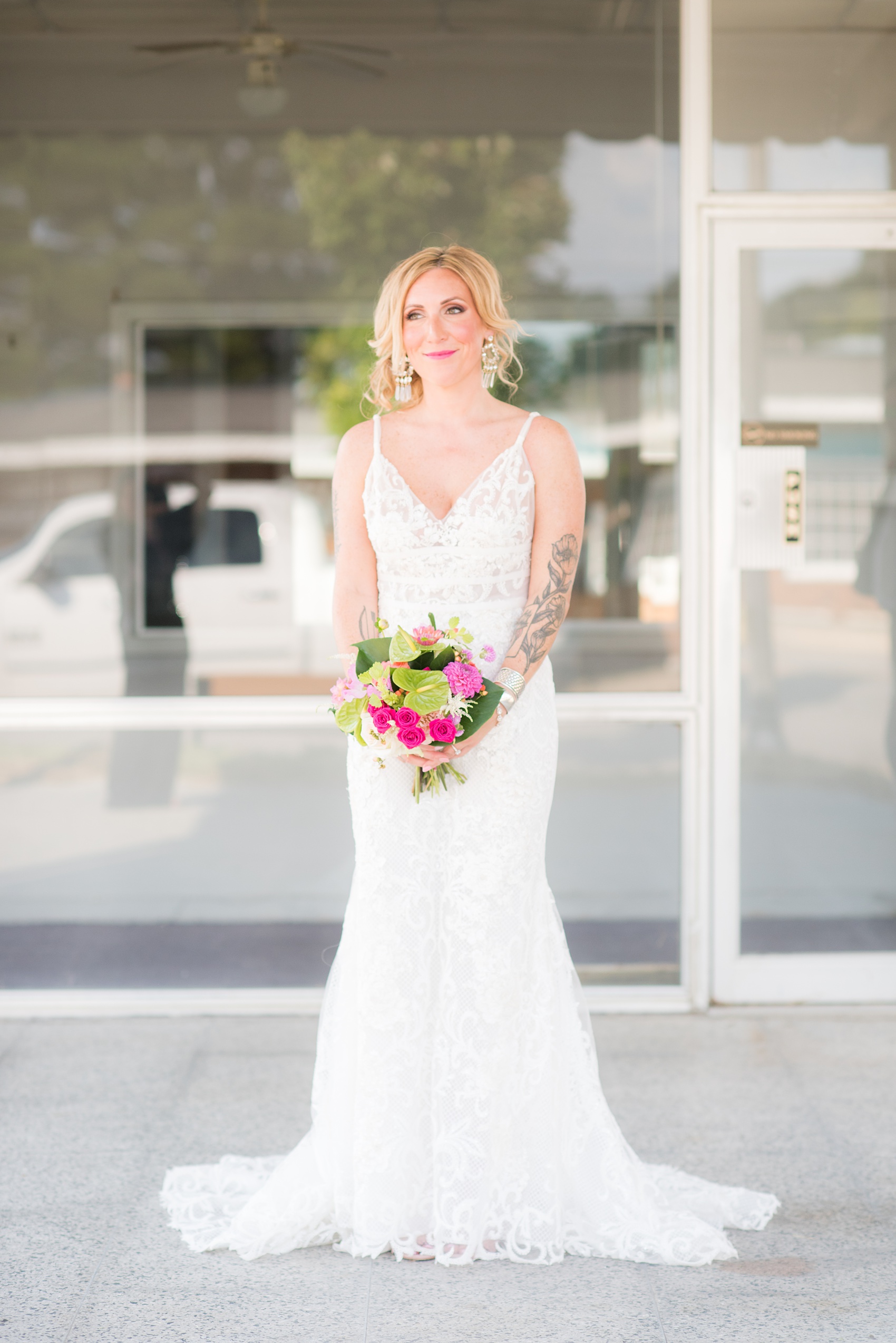 Highgrove Estate wedding photos in North Carolina by Mikkel Paige Photography. This tattooed bride wore a lace gown and her style beautiful personality matched her awesome reception details. They had a pink + green palette, planned by @asouthernsoiree, with tropical flowers + floral patterns on custom stationery. Click through for beautiful ideas for their outdoor party! #NorthCarolinaVenues #WeddingVenues #MikkelPaige #ASouthernSoiree #tropicalflowers #bridestyle #tattooedbride #bride