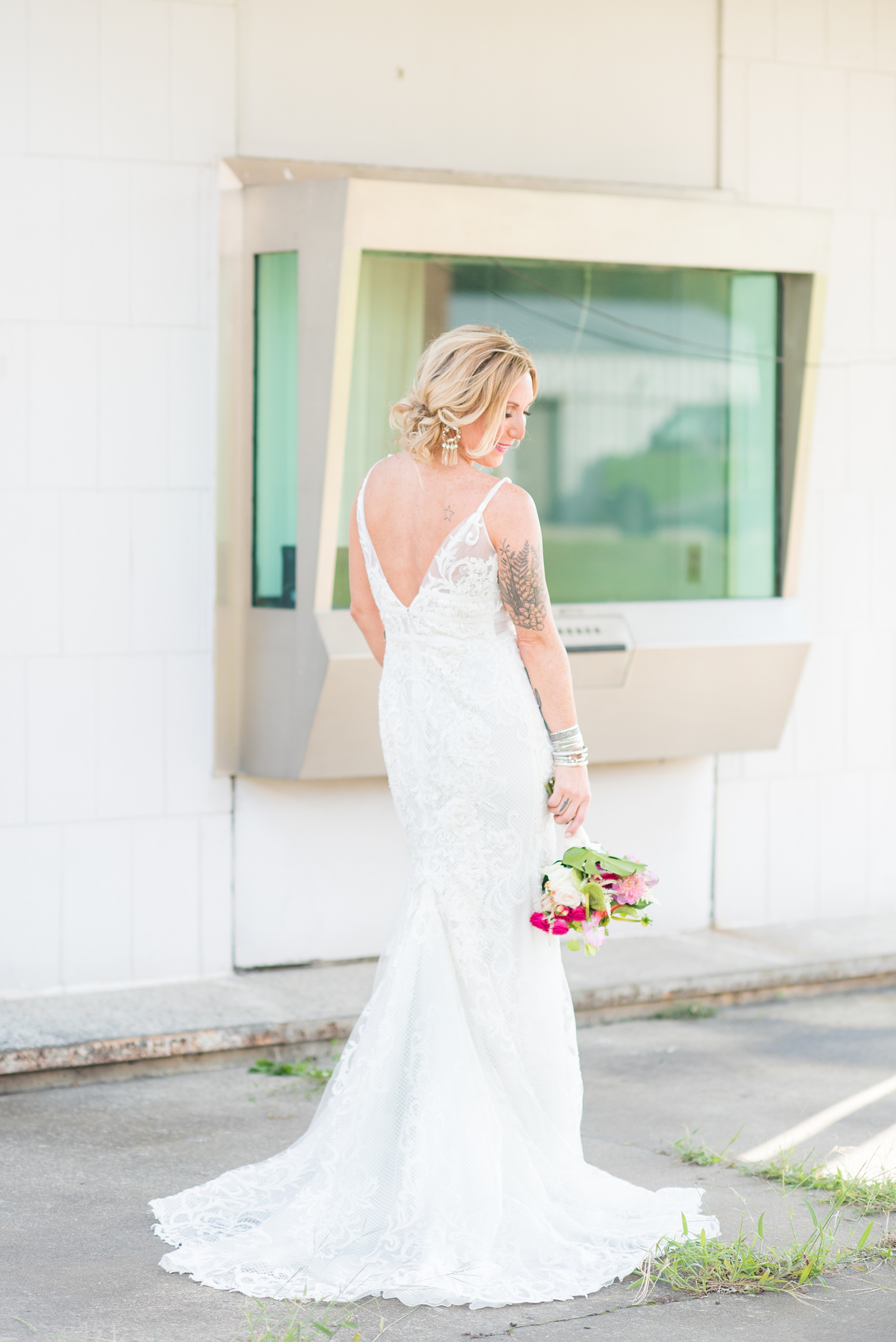 Highgrove Estate wedding photos in North Carolina by Mikkel Paige Photography. This tattooed bride wore a lace gown and her style beautiful personality matched her awesome reception details. They had a pink + green palette, planned by @asouthernsoiree, with tropical flowers + floral patterns on custom stationery. Click through for beautiful ideas for their outdoor party! #NorthCarolinaVenues #WeddingVenues #MikkelPaige #ASouthernSoiree #tropicalflowers #bridestyle #tattooedbride #bride