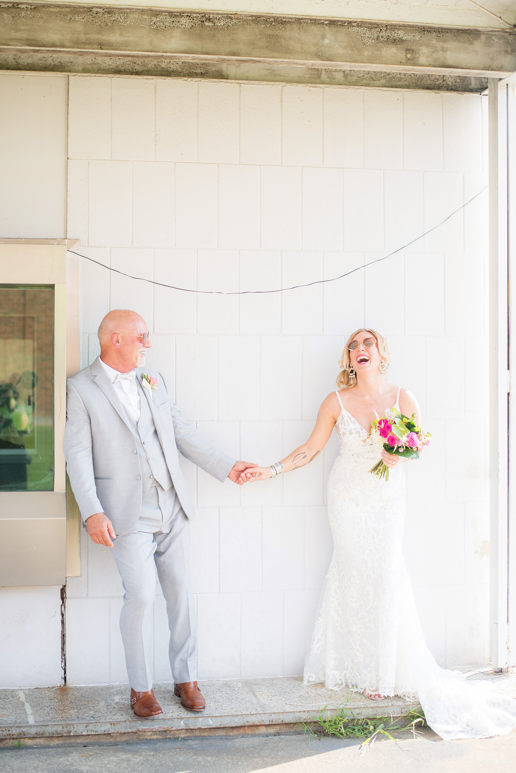 Highgrove Estate wedding photos in North Carolina by Mikkel Paige Photography. This tattooed bride + groom wanted playful, urban pictures in downtown Fuquay-Varina, near Raleigh. They had a pink + green palette, planned by @asouthernsoiree, with tropical flowers and balloons for their tented dinner. Click through for all the details for their awesome party! #NorthCarolinaVenues #WeddingVenues #MikkelPaige #ASouthernSoiree #tropicalflowers #brideandgroom #tattooedbride #weddingdetails