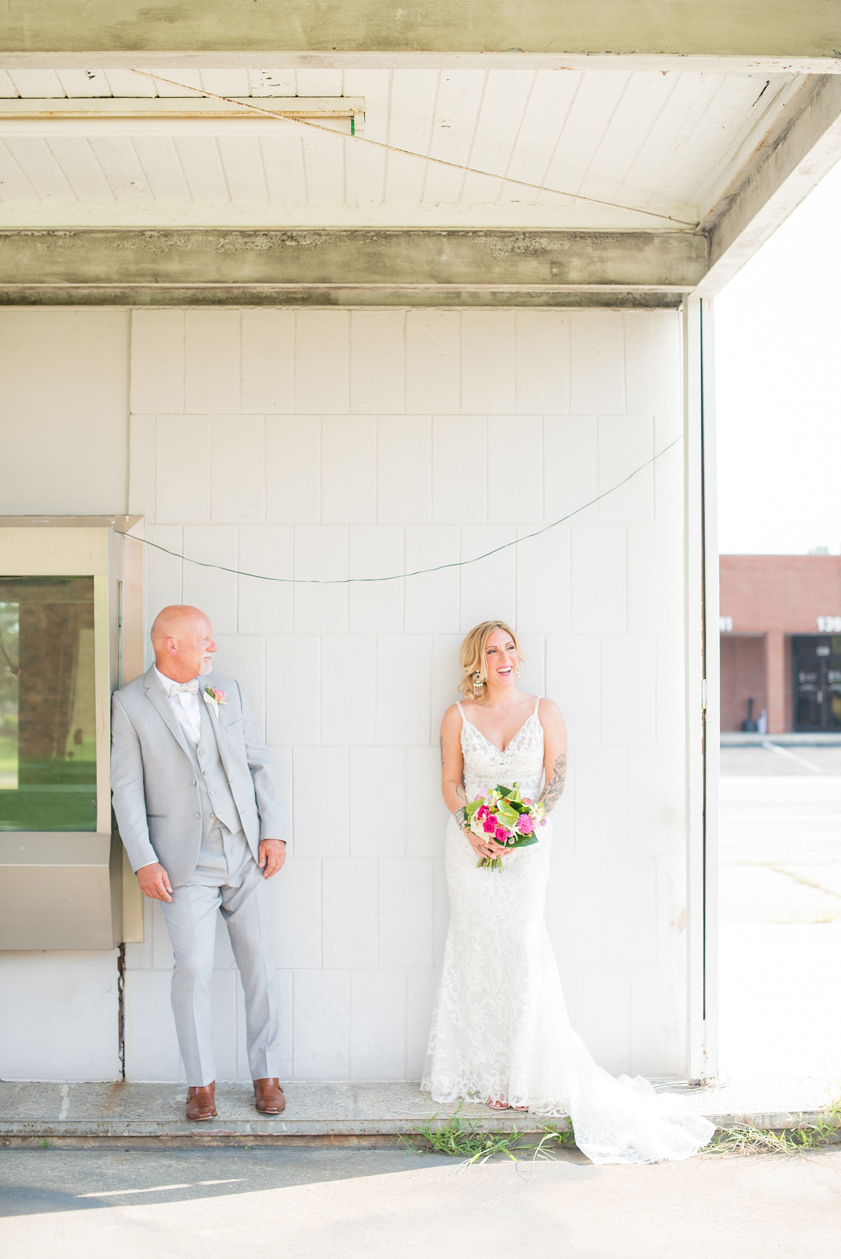 Highgrove Estate wedding photos in North Carolina by Mikkel Paige Photography. This tattooed bride + groom wanted playful, urban pictures in downtown Fuquay-Varina, near Raleigh. They had a pink + green palette, planned by @asouthernsoiree, with tropical flowers and balloons for their tented dinner. Click through for all the details for their awesome party! #NorthCarolinaVenues #WeddingVenues #MikkelPaige #ASouthernSoiree #tropicalflowers #brideandgroom #tattooedbride #weddingdetails