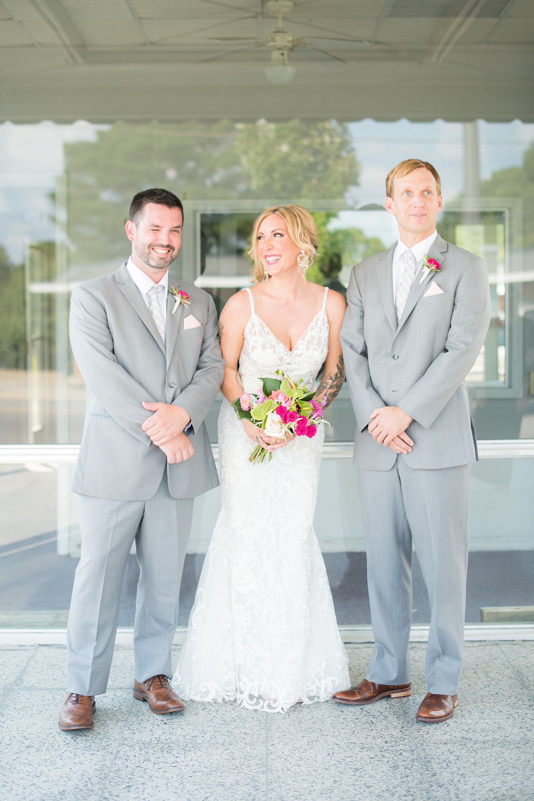 Highgrove Estate wedding photos in North Carolina by Mikkel Paige Photography. The bride + groom wanted urban, rustic pictures outdoors in downtown Fuquay-Varina with their wedding party, near Raleigh. They had a pink + green palette, planned by @asouthernsoiree, with tropical flowers for their tented dinner. The groomsmen wore grey + pink, and maid of honor a floral pattern dress. Click for pictures from their awesome party! #NorthCarolinaVenues #MikkelPaige #ASouthernSoiree #weddingparty