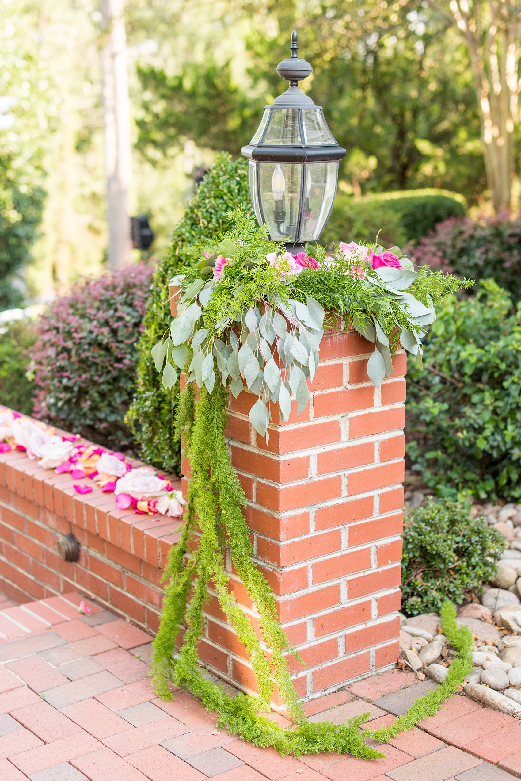 Highgrove Estate wedding photos by Mikkel Paige Photography. It’s a beautiful venue for a wedding large or small, near Raleigh, North Carolina. This wedding had fun signs, custom stationery and table numbers that said places the bride & groom travel to, and romantic candlelight planned by @asouthernsoiree. Click through to see the tropical green leaves, pink and orange flowers dripping from their outdoor ceremony space! #NorthCarolinaVenues #MikkelPaige #ASouthernSoiree #OutdoorCeremony