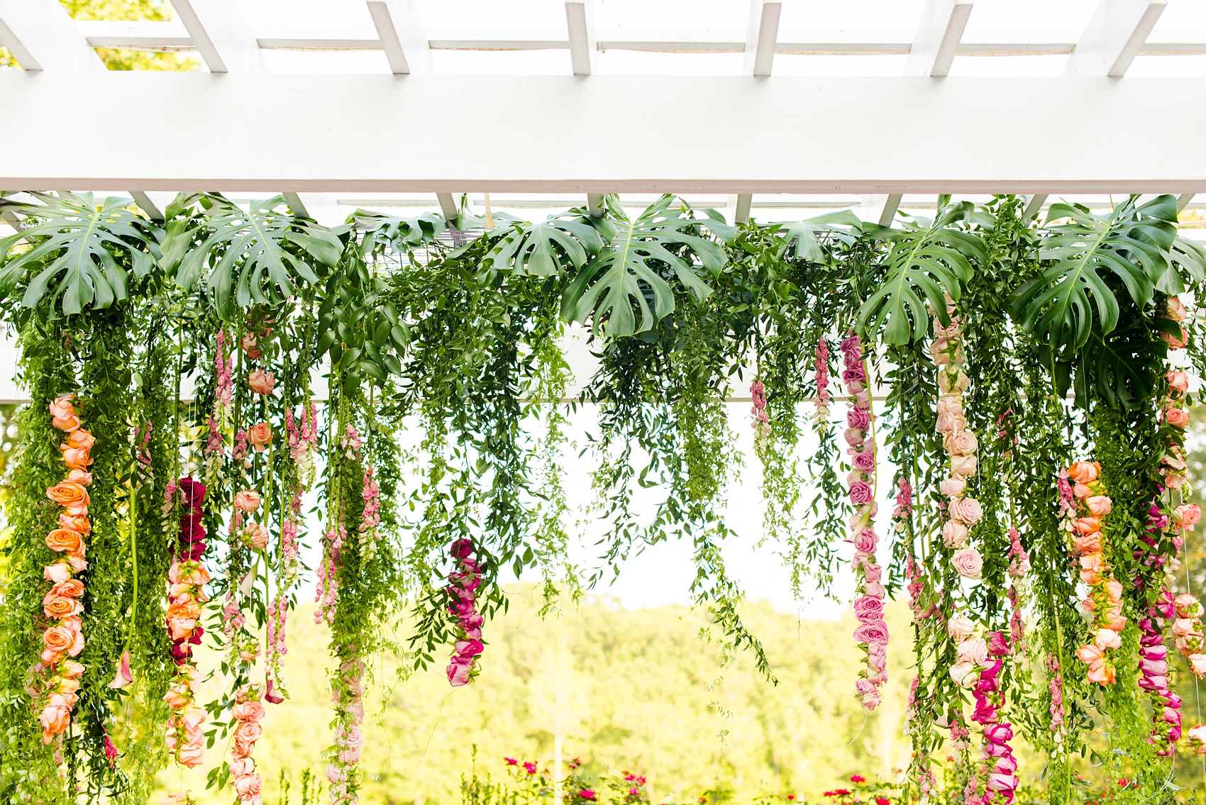 Highgrove Estate wedding photos by Mikkel Paige Photography. It’s a beautiful venue for a wedding large or small, near Raleigh, North Carolina. This wedding had fun signs, custom stationery and table numbers that said places the bride & groom travel to, and romantic candlelight planned by @asouthernsoiree. Click through to see the tropical green leaves, pink and orange flowers dripping from their outdoor ceremony space! #NorthCarolinaVenues #MikkelPaige #ASouthernSoiree #OutdoorCeremony