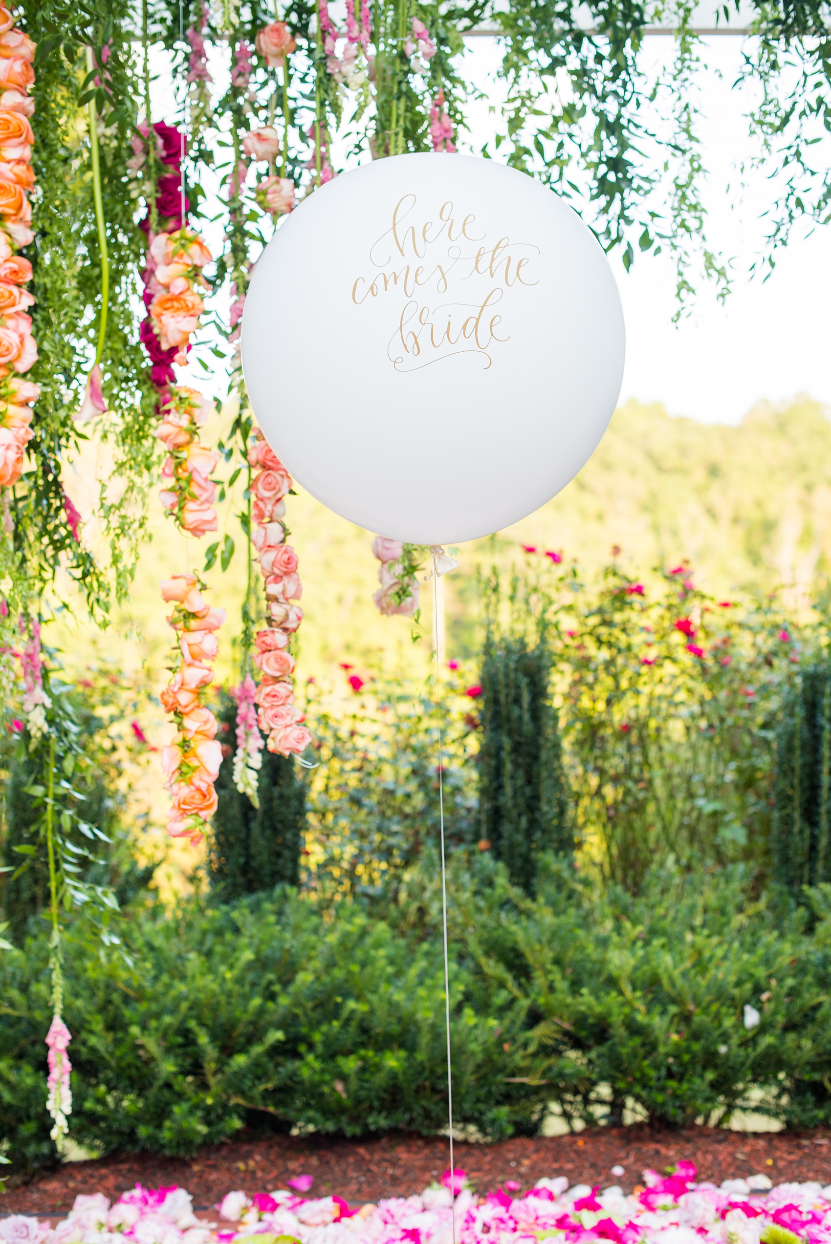 Highgrove Estate wedding photos by Mikkel Paige Photography. It’s a beautiful venue for a wedding large or small, near Raleigh, North Carolina. This wedding had fun signs, custom stationery and table numbers that said places the bride & groom travel to, and romantic candlelight planned by @asouthernsoiree. Click through to see the tropical green leaves, pink and orange flowers dripping from their outdoor ceremony space! #NorthCarolinaVenues #MikkelPaige #ASouthernSoiree #OutdoorCeremony