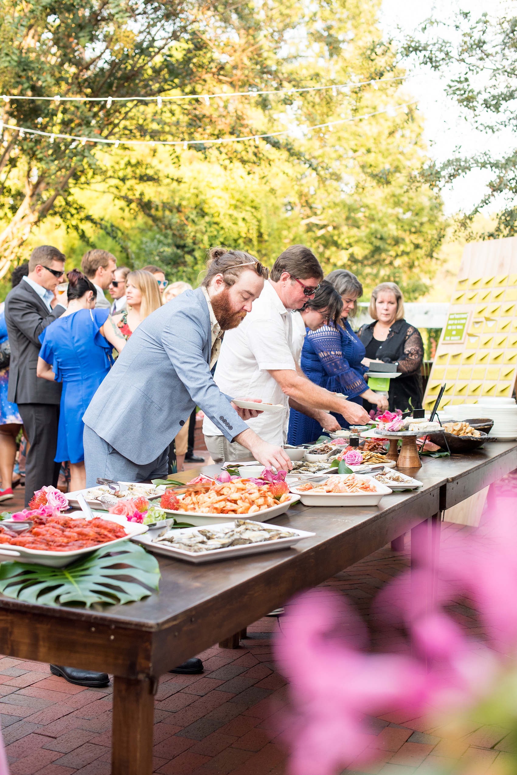 Highgrove Estate wedding photos by Mikkel Paige Photography. This beautiful venue works for a wedding large or small, near Raleigh, North Carolina. Their in-house catering is awesome: just look at this raw bar spread and charcuterie! The romantic celebration was planned by @asouthernsoiree. Click through to see the pink and green tropical flowers dripping from their tented, balloon-filled reception space! #MikkelPaige #ASouthernSoiree #rawbar #cocktailhour