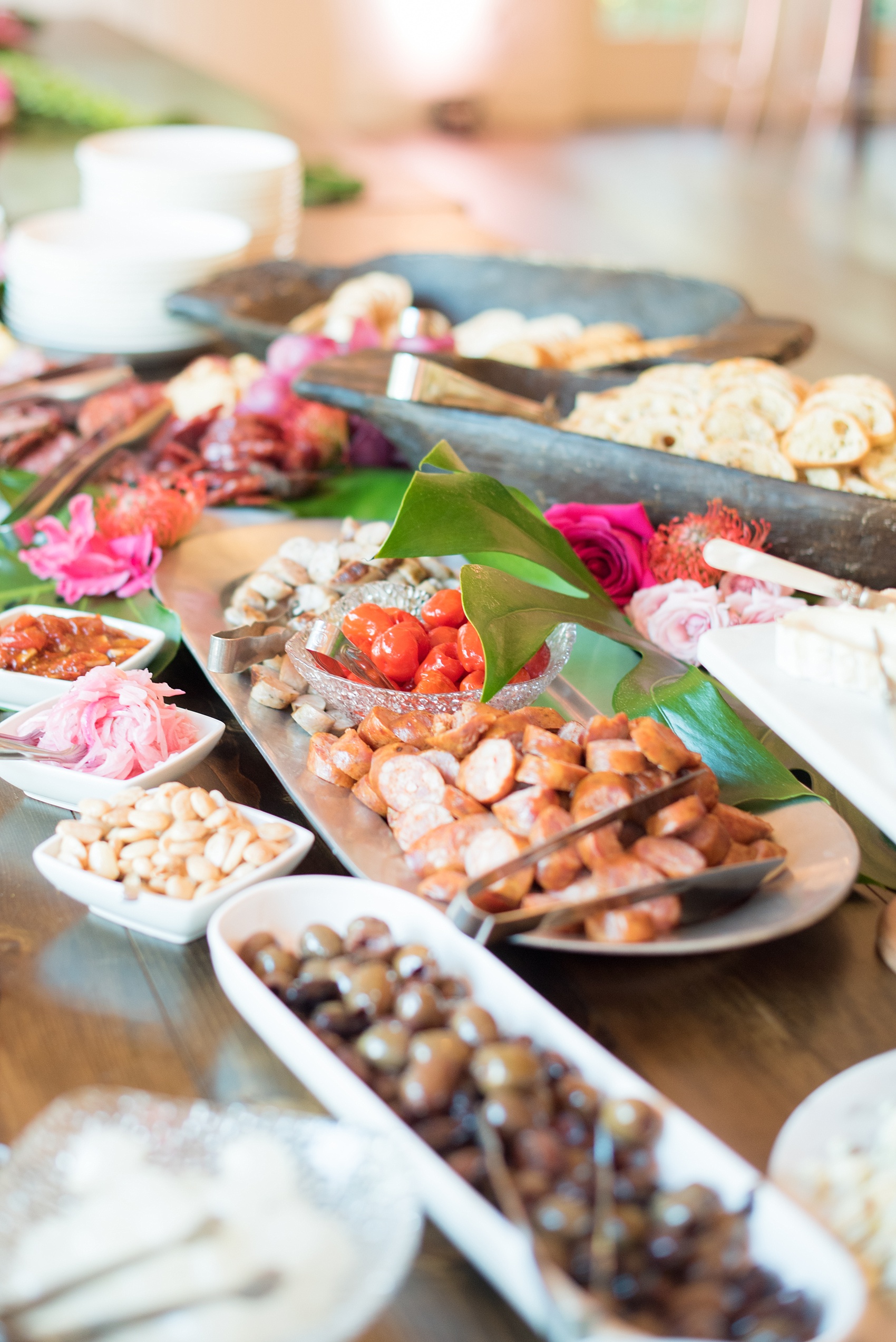 Highgrove Estate wedding photos by Mikkel Paige Photography. This beautiful venue works for a wedding large or small, near Raleigh, North Carolina. Their in-house catering is awesome: just look at this raw bar spread and charcuterie! The romantic celebration was planned by @asouthernsoiree. Click through to see the pink and green tropical flowers dripping from their tented, balloon-filled reception space! #MikkelPaige #ASouthernSoiree #rawbar #cocktailhour