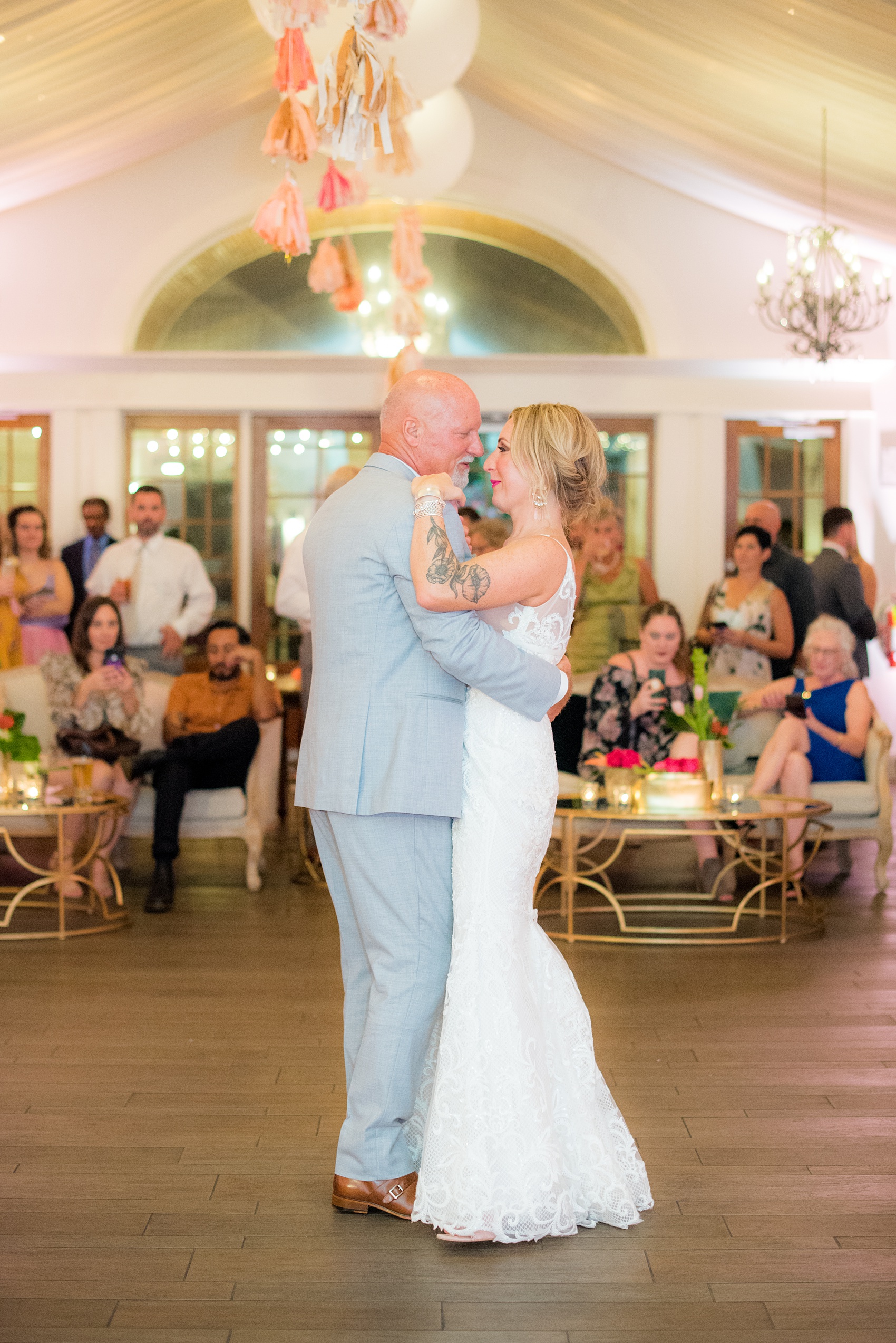 Highgrove Estate wedding photos by Mikkel Paige Photography. This beautiful venue is for a celebration large or small near Raleigh, North Carolina. The couple had awesome custom signs and table numbers that said places they traveled to by @oneandonlypaper, + romantic candlelight in a lounge space planned by @asouthernsoiree with colorful furniture and festive balloons and tassels on the ceiling. Click through to see how amazing the total space was! #MikkelPaige #ASouthernSoiree #firstdance