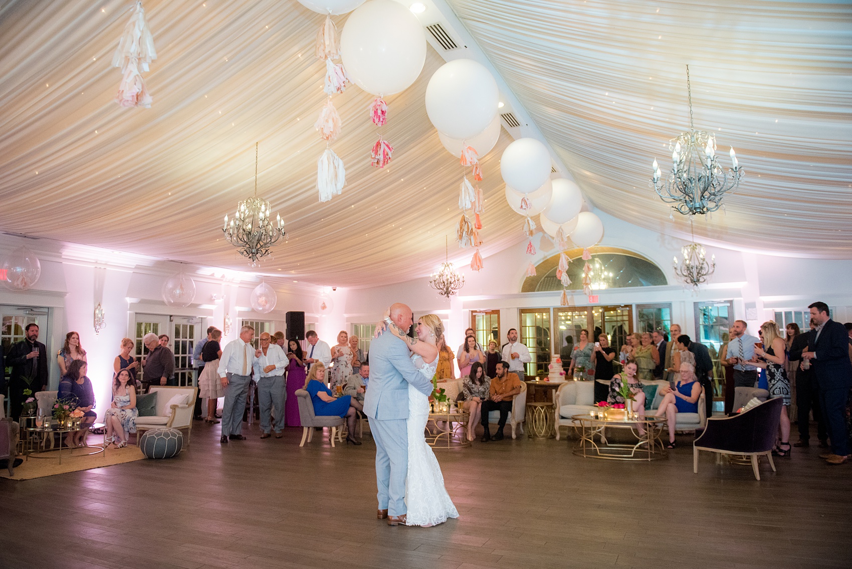 Highgrove Estate wedding photos by Mikkel Paige Photography. This beautiful venue is for a celebration large or small near Raleigh, North Carolina. The couple had awesome custom signs and table numbers that said places they traveled to by @oneandonlypaper, + romantic candlelight in a lounge space planned by @asouthernsoiree with colorful furniture and festive balloons and tassels on the ceiling. Click through to see how amazing the total space was! #MikkelPaige #ASouthernSoiree #firstdance