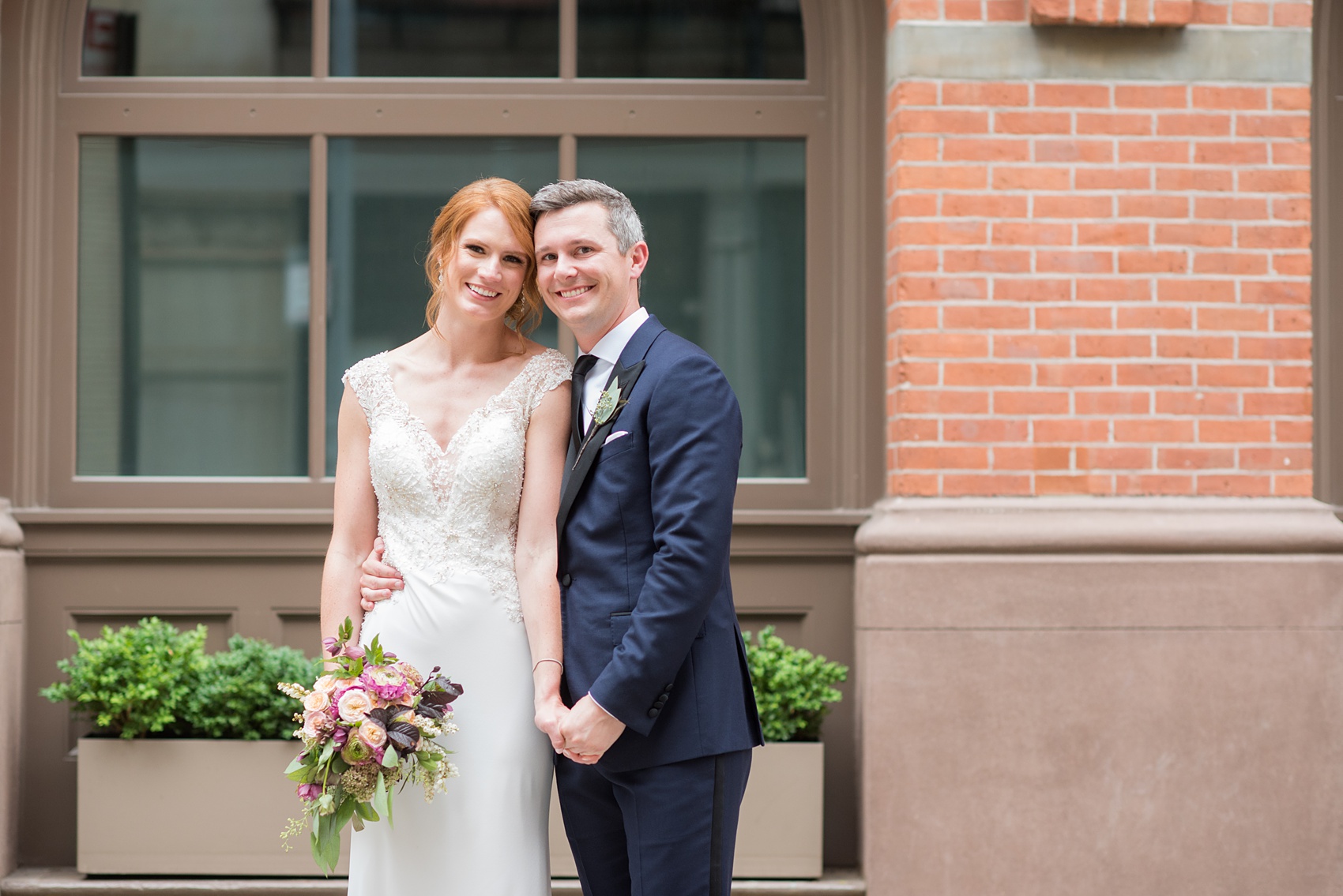 Photos of a NYC wedding venue, Tribeca Rooftop, by Mikkel Paige Photography. This ceremony and reception location has an outdoor space overlooking the Manhattan skyline. These pictures of the bride and groom will provide inspiration in New York! She wore a lace illusion gown with beading, her hair up, and carried a bouquet of fall flowers and he was in a navy suit. Click through for more details from this celebration! #TribecaRooftop #MikkelPaige #NYCwedding #NYCWeddingVenues #BrideandGroom 