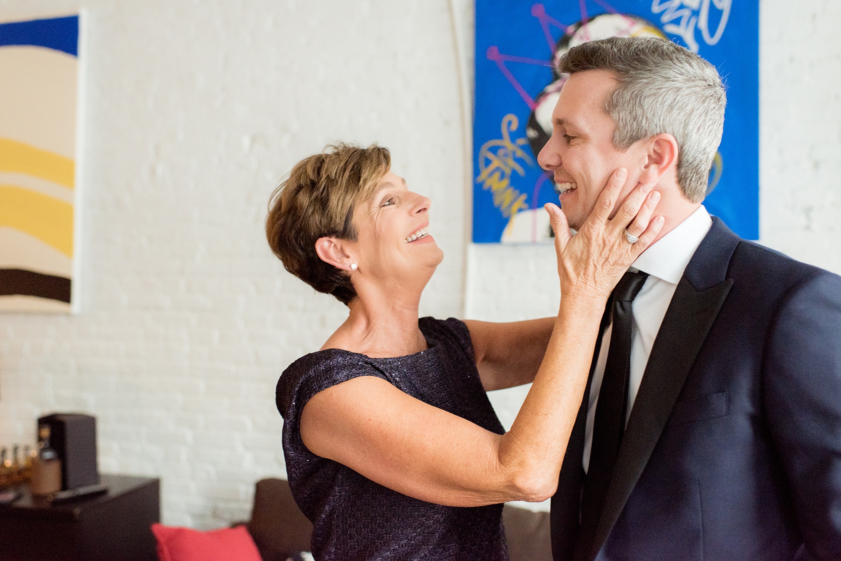 Photos of a NYC wedding venue, Tribeca Rooftop, by Mikkel Paige Photography. This ceremony and reception location has an outdoor space overlooking the Manhattan skyline. These pictures will provide inspiration in New York! The groom wore a simple leaf boutonniere on his navy suit. Click through for more details from this celebration! #TribecaRooftop #MikkelPaige #NYCwedding #NYCWeddingVenues #NYCWeddingPhotography #groomsuit