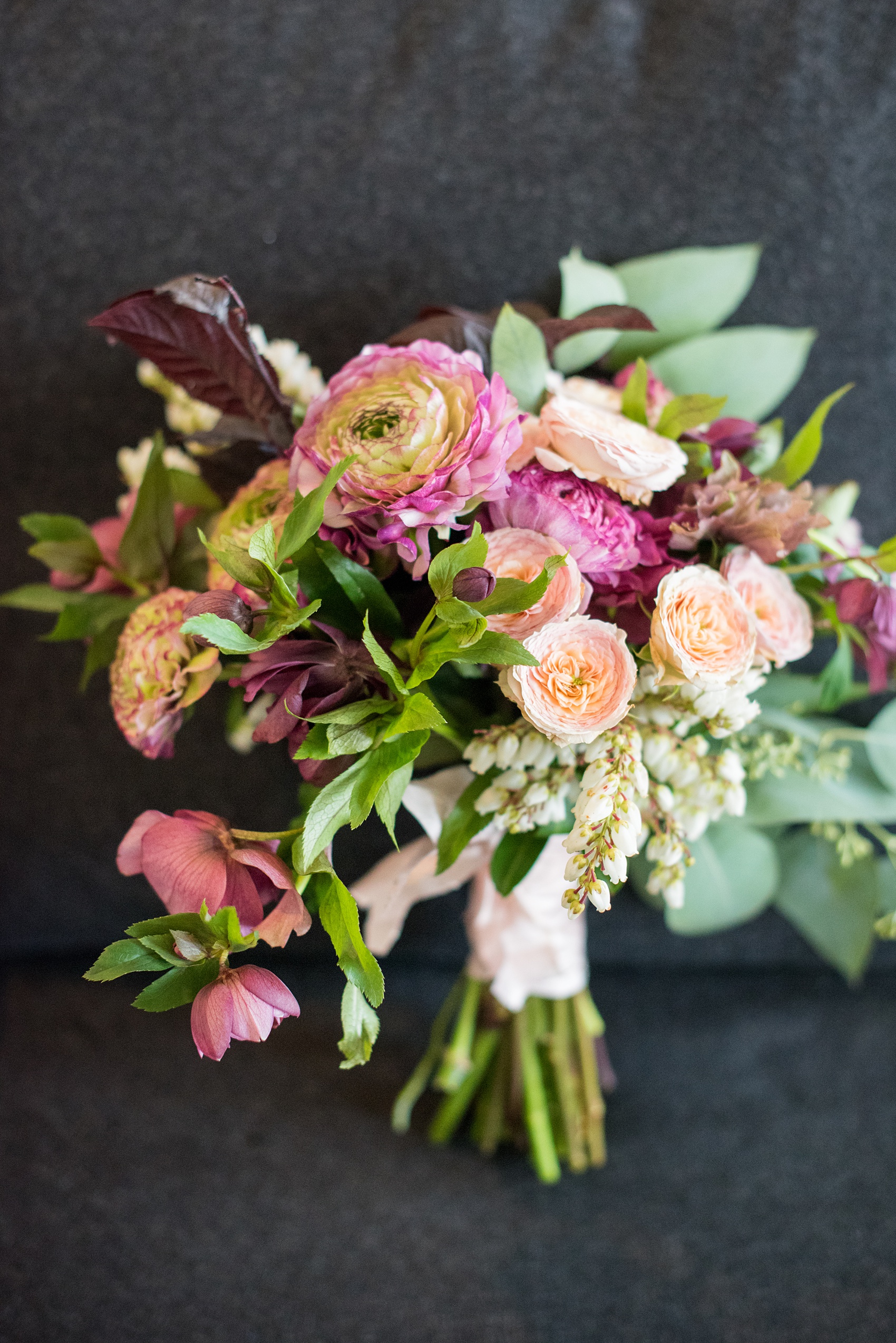 Photos of a NYC wedding venue, Tribeca Rooftop, by Mikkel Paige Photography. This ceremony and reception location has an outdoor space overlooking the Manhattan skyline. These pictures will provide inspiration in New York! Fall flowers were plentiful in bouquets and centerpieces, including red, purples, whites and pinks. Click through for more details from this celebration! #TribecaRooftop #MikkelPaige #NYCwedding #NYCWeddingVenues #NYCWeddingPhotography #FallFlowers #Ranunculus #Dahlias