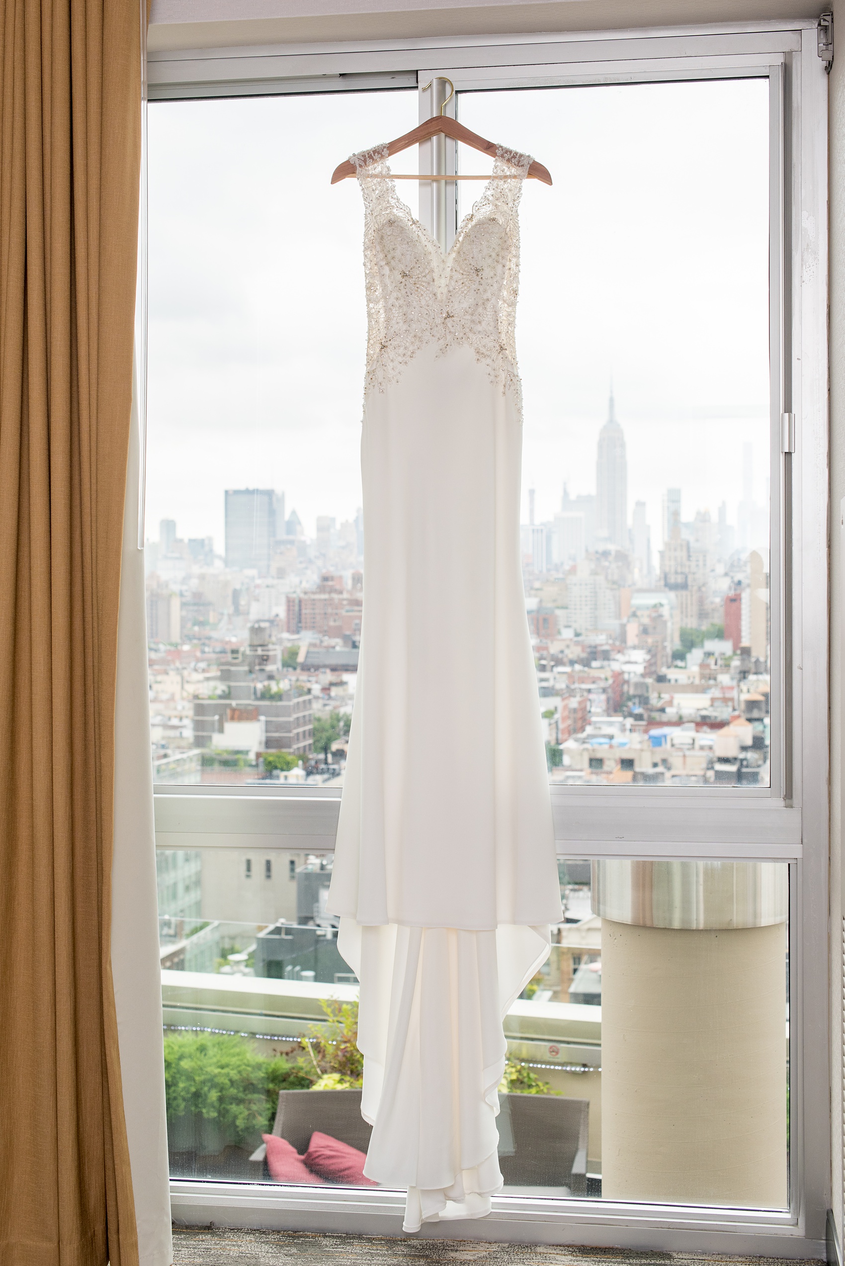 Photos of a NYC wedding venue, Tribeca Rooftop, by Mikkel Paige Photography. This ceremony and reception location has an outdoor space overlooking the Manhattan skyline. These pictures will provide inspiration in New York! The bride wore a lace illusion gown with beading, her hair up, and carried a bouquet of fall flowers. Click through for more details from this celebration! #TribecaRooftop #MikkelPaige #NYCwedding #NYCWeddingVenues #NYCWeddingPhotography #BridalGown #RKBridal