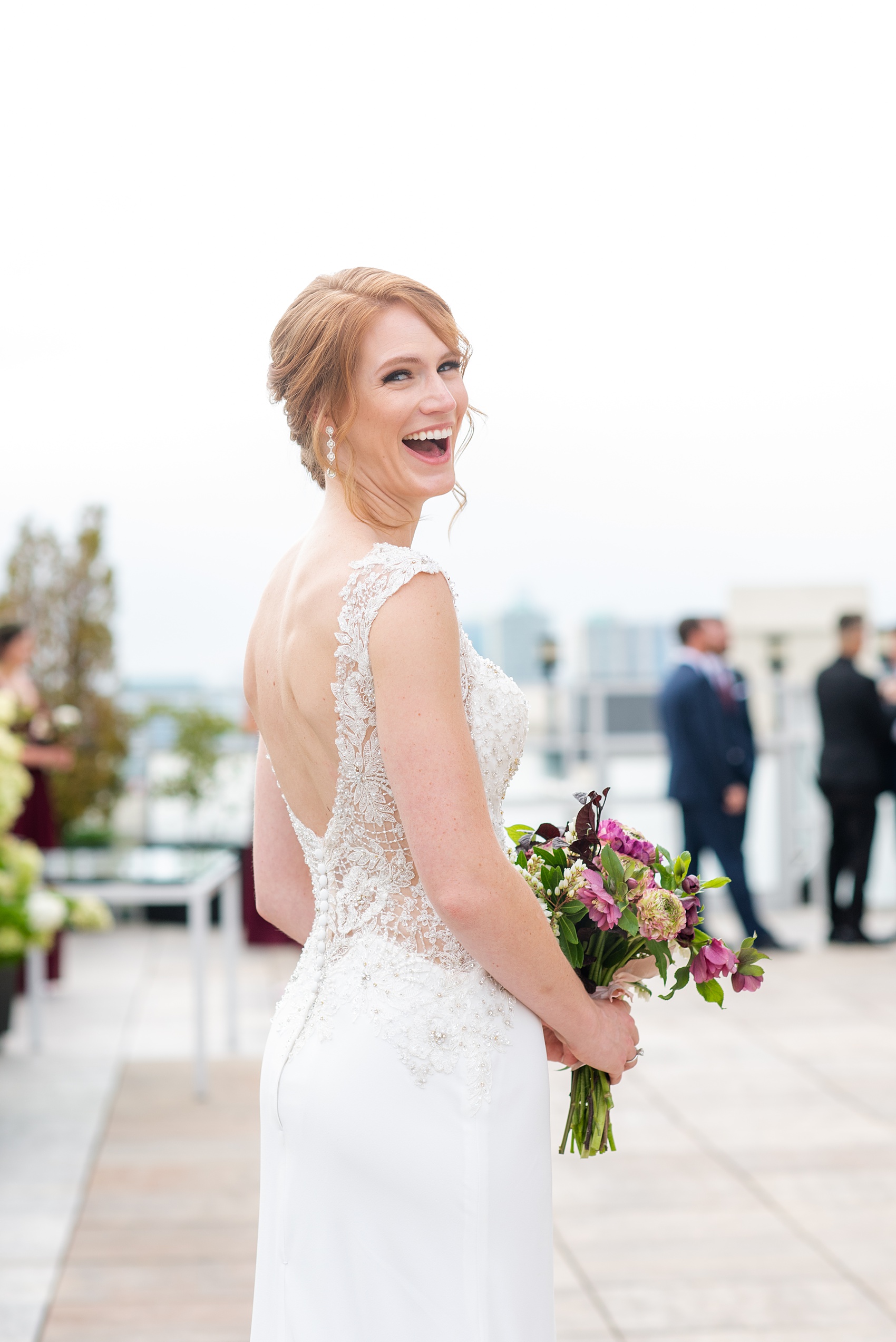 Photos of a NYC wedding venue, Tribeca Rooftop, by Mikkel Paige Photography. This ceremony and reception location has an outdoor space overlooking the Manhattan skyline. These pictures will provide inspiration in New York! The bride wore a lace illusion gown with beading, her hair up, and carried a bouquet of fall flowers. Click through for more details from this celebration! #TribecaRooftop #MikkelPaige #NYCwedding #NYCWeddingVenues #NYCWeddingPhotography #Ranunculus #FallBouquet 