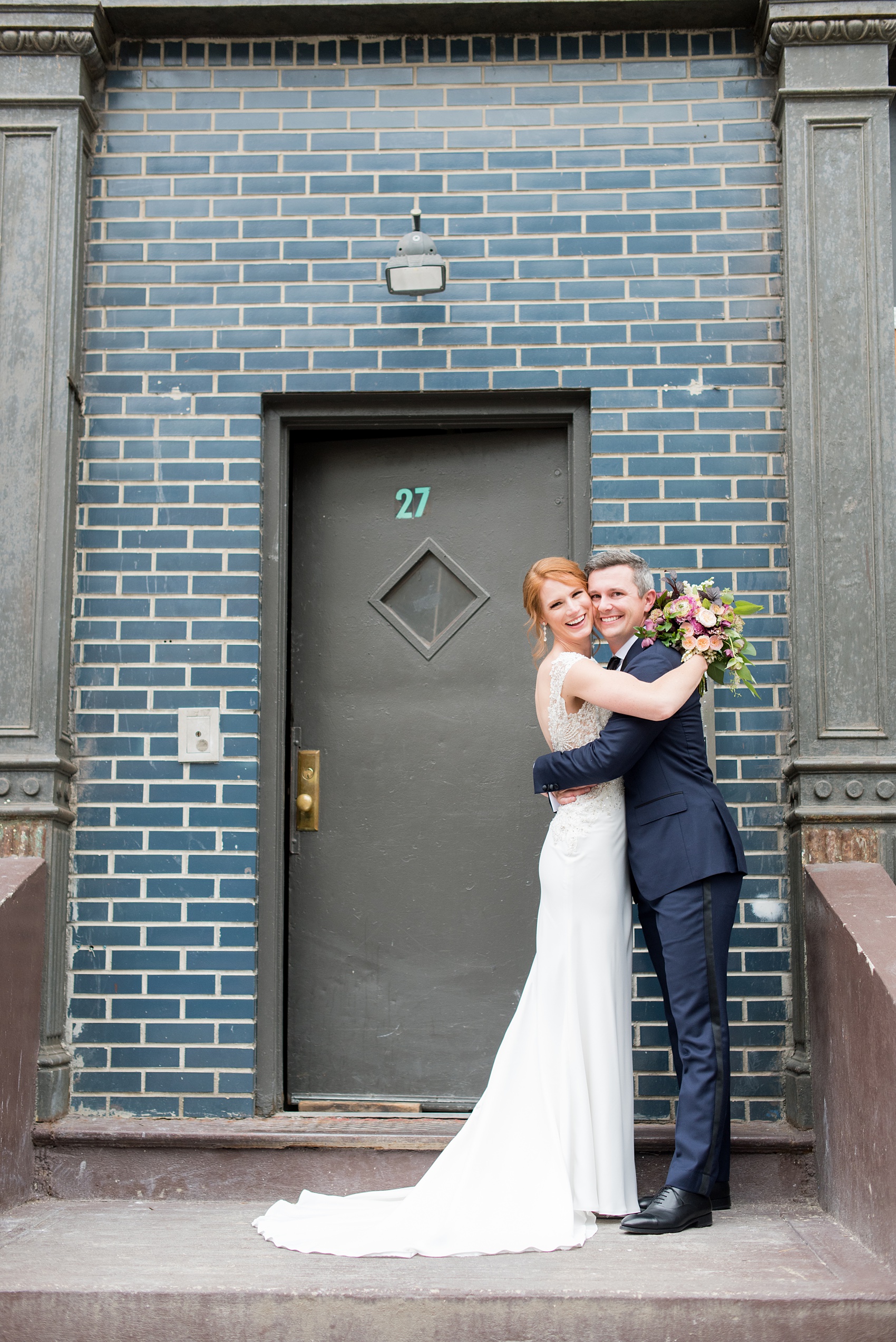 Photos of a NYC wedding venue, Tribeca Rooftop, by Mikkel Paige Photography. This ceremony and reception location has an outdoor space overlooking the Manhattan skyline. These pictures of the bride and groom will provide inspiration in New York! She wore a lace illusion gown with beading, her hair up, and carried a bouquet of fall flowers and he was in a navy suit. Click through for more details from this celebration! #TribecaRooftop #MikkelPaige #NYCwedding #NYCWeddingVenues #BrideandGroom 