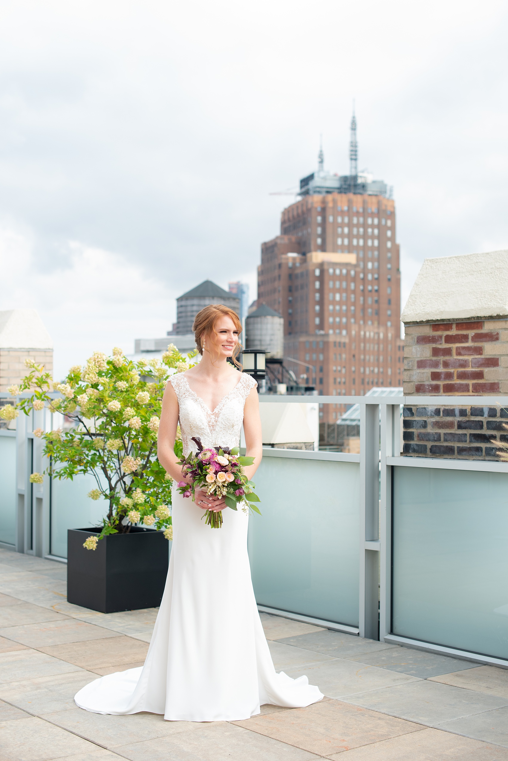 Photos of a NYC wedding venue, Tribeca Rooftop, by Mikkel Paige Photography. This ceremony and reception location has an outdoor space overlooking the Manhattan skyline. These pictures will provide inspiration in New York! The bride wore a lace illusion gown with beading, her hair up, and carried a bouquet of fall flowers. Click through for more details from this celebration! #TribecaRooftop #MikkelPaige #NYCwedding #NYCWeddingVenues #NYCWeddingPhotography #Ranunculus #FallBouquet 