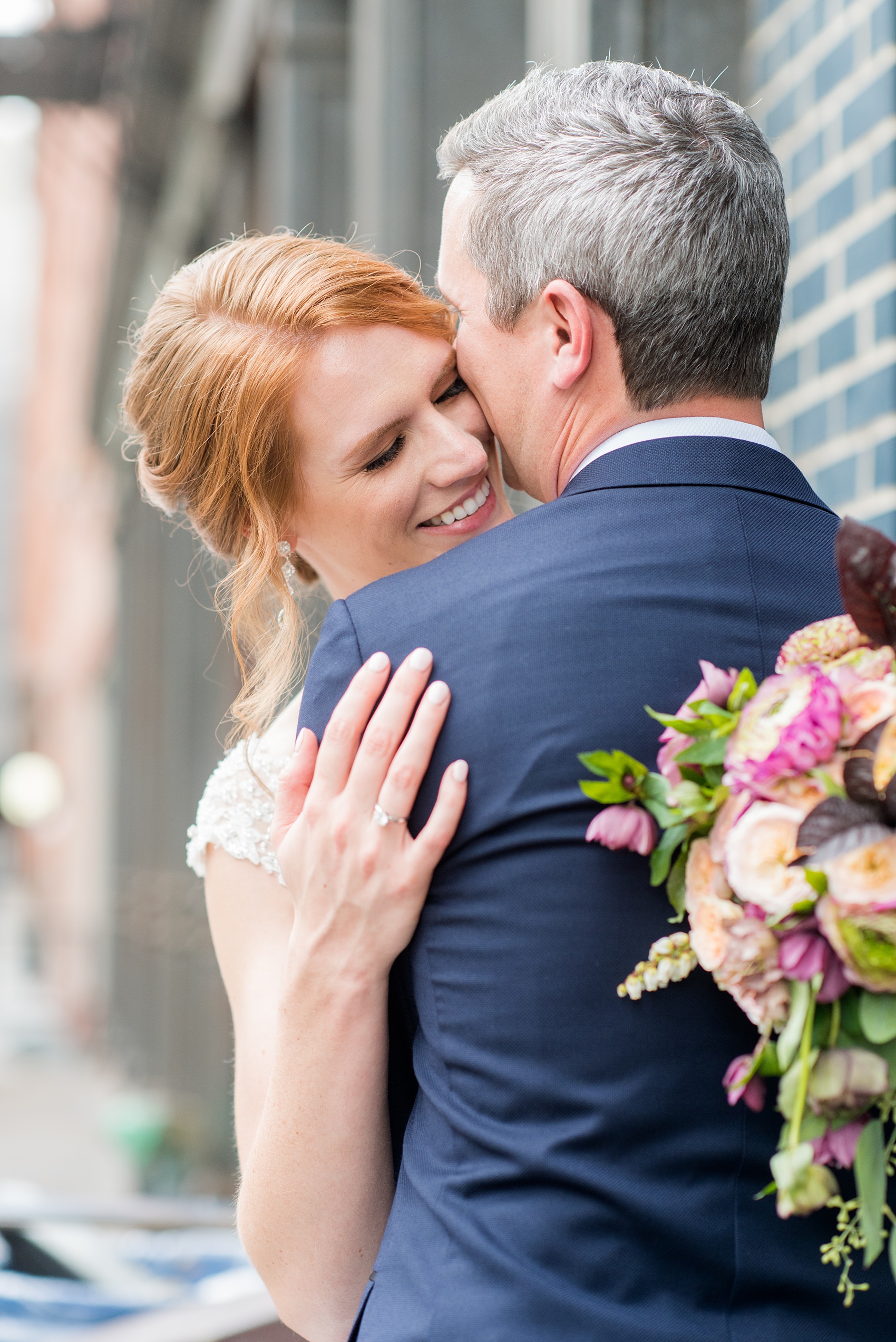 Photos of a NYC wedding venue, Tribeca Rooftop, by Mikkel Paige Photography. This ceremony and reception location has an outdoor space overlooking the Manhattan skyline. These pictures of the bride and groom will provide inspiration in New York! She wore a lace illusion gown with beading, her hair up, and carried a bouquet of fall flowers and he was in a navy suit. Click through for more details from this celebration! #TribecaRooftop #MikkelPaige #NYCwedding #NYCWeddingVenues #BrideandGroom 