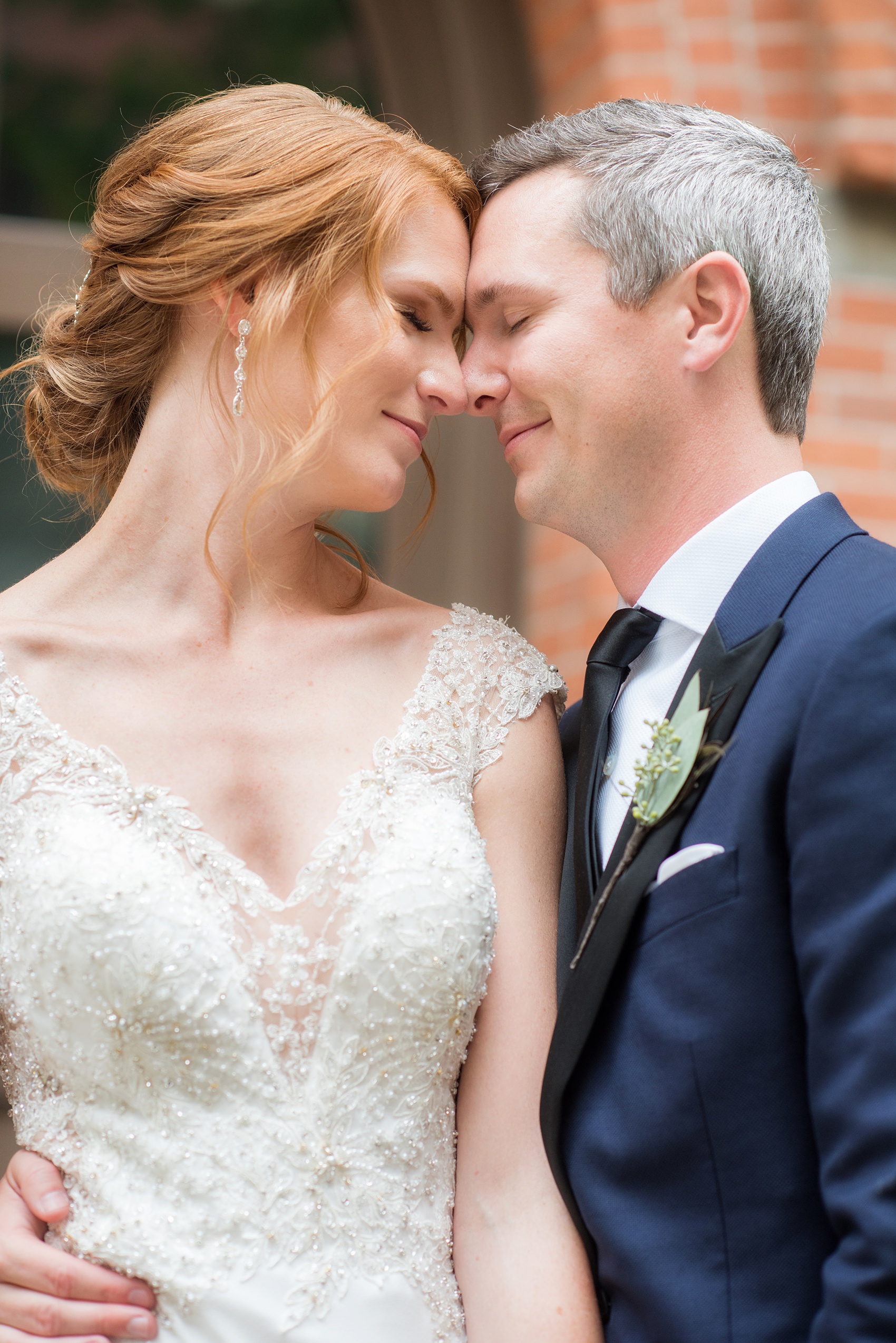 Photos of a NYC wedding venue, Tribeca Rooftop, by Mikkel Paige Photography. This ceremony and reception location has an outdoor space overlooking the Manhattan skyline. These pictures of the bride and groom will provide inspiration in New York! She wore a lace illusion gown with beading, her hair up, and carried a bouquet of fall flowers and he was in a navy suit. Click through for more details from this celebration! #TribecaRooftop #MikkelPaige #NYCwedding #NYCWeddingVenues #BrideandGroom 