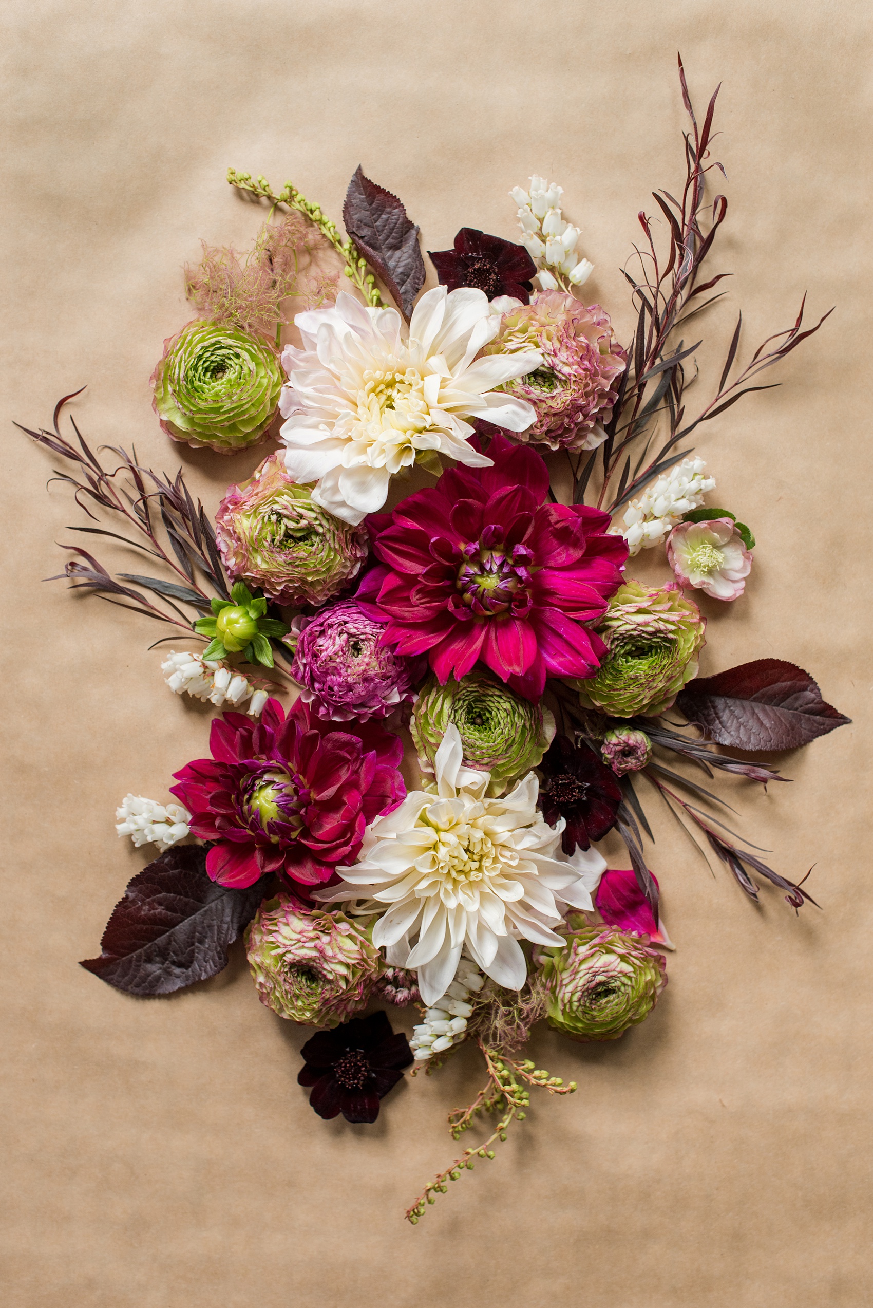 Photos of a NYC wedding venue, Tribeca Rooftop, by Mikkel Paige Photography. This ceremony and reception location has an outdoor space overlooking the Manhattan skyline. These pictures will provide inspiration in New York! Fall flowers were plentiful in bouquets and centerpieces, including red, purples, whites and pinks. Click through for more details from this celebration! #TribecaRooftop #MikkelPaige #NYCwedding #NYCWeddingVenues #NYCWeddingPhotography #FallFlowers #Ranunculus #Dahlias