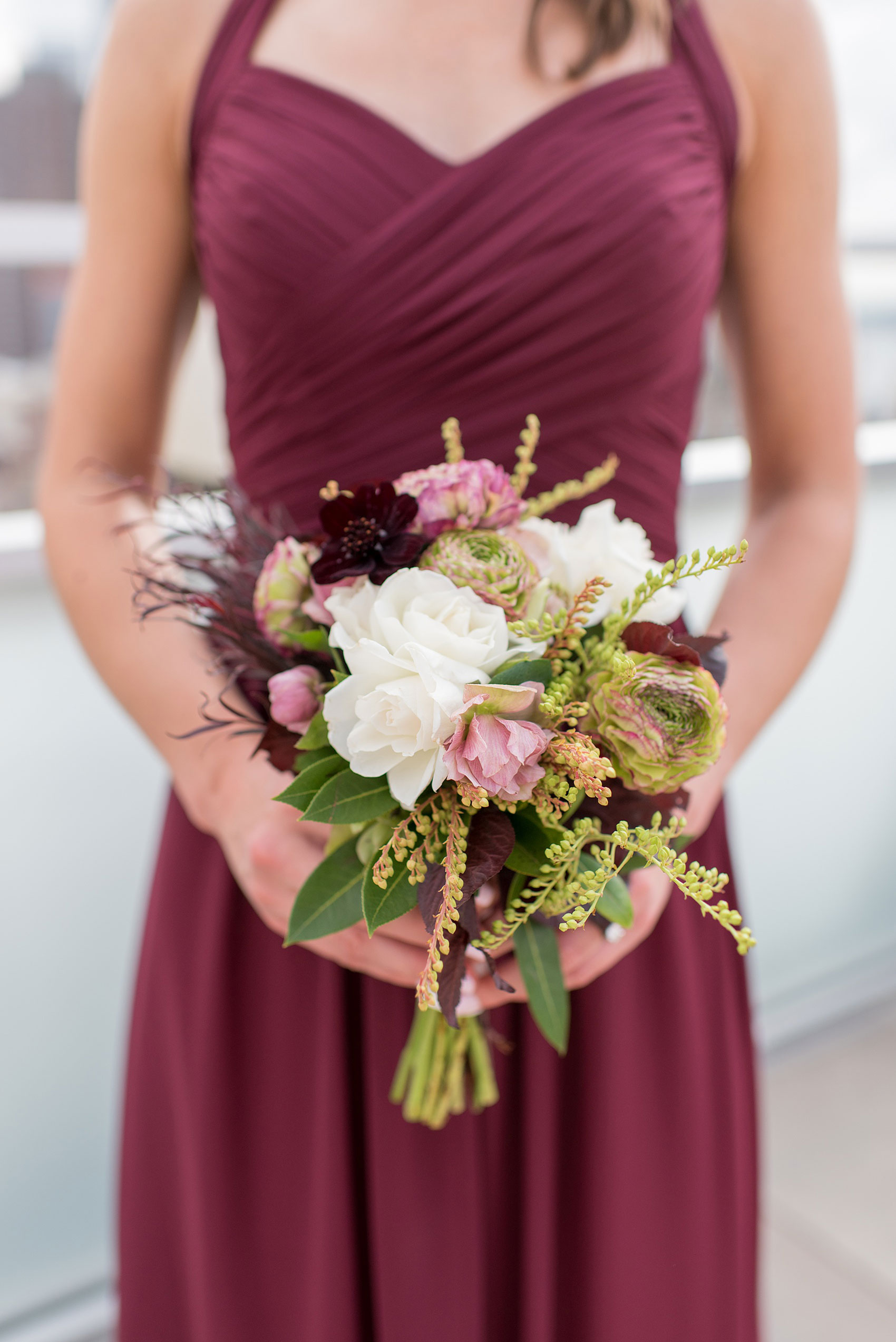 Photos of a NYC wedding venue, Tribeca Rooftop, by Mikkel Paige Photography. This ceremony and reception location has an outdoor space overlooking the Manhattan skyline. These pictures will provide inspiration in New York! Fall flowers were plentiful in bouquets and centerpieces, including red, purples, whites and pinks. Click through for more details from this celebration! #TribecaRooftop #MikkelPaige #NYCwedding #NYCWeddingVenues #NYCWeddingPhotography #FallFlowers #Ranunculus #Dahlias
