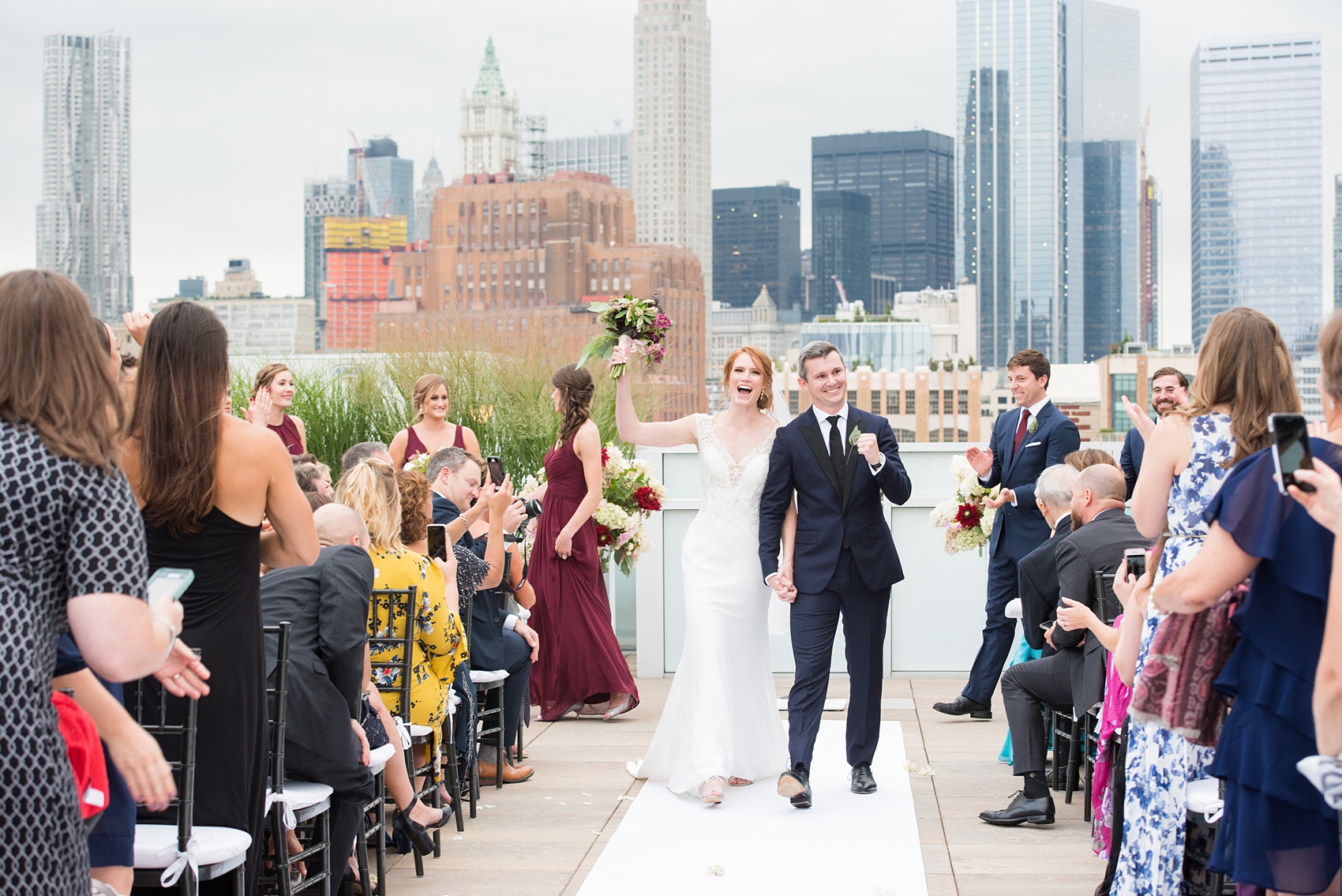Photos of a NYC wedding venue, Tribeca Rooftop, by Mikkel Paige Photography. This ceremony and reception location has an outdoor space overlooking the Manhattan skyline. These pictures will provide inspiration in New York! The couple dreamed of getting married in this awesome city with flowers and colors of fall. Click through for more details from this beautiful celebration! #TribecaRooftop #NYCVenues #MikkelPaige #NYCwedding #NYCskyline #NYCWeddingPhotos #NYCWeddingPhotography