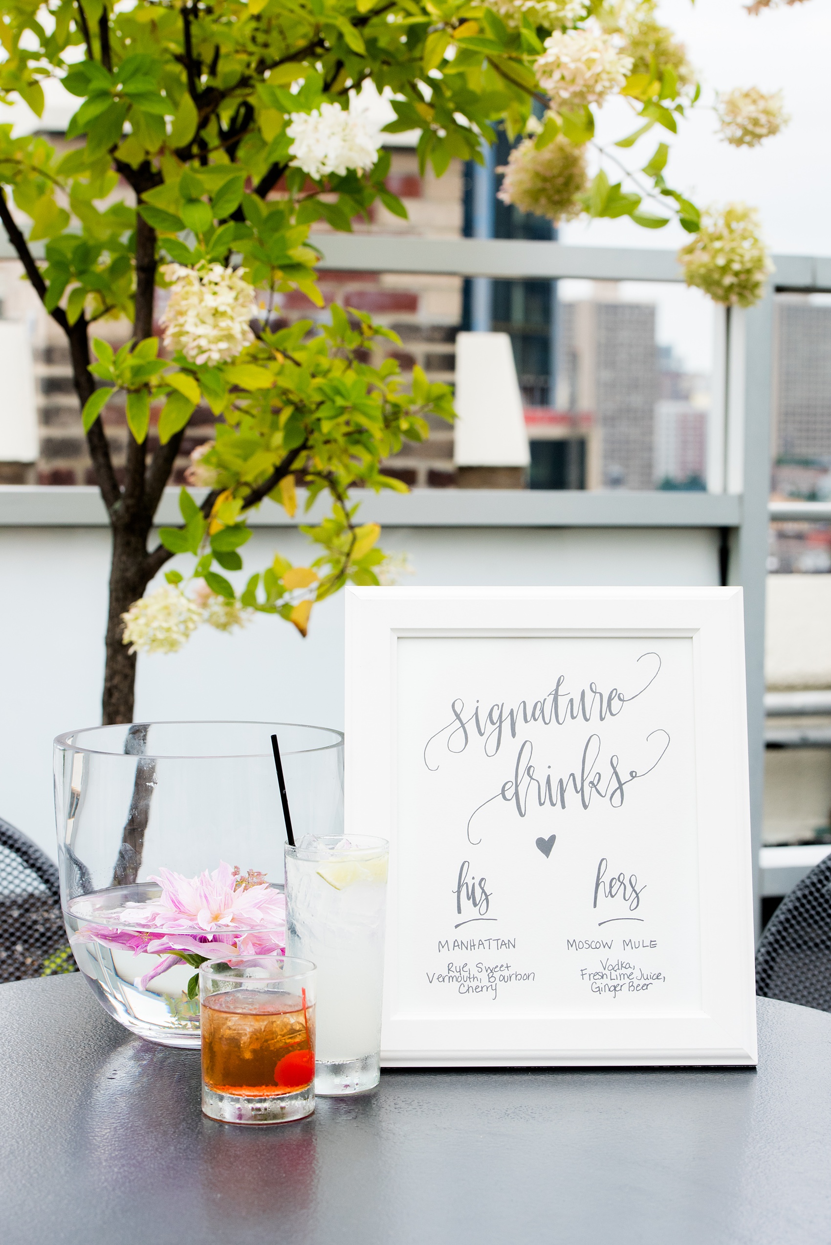 Photos of a NYC wedding venue, Tribeca Rooftop, by Mikkel Paige Photography. This ceremony and reception location has an outdoor space overlooking the Manhattan skyline. These pictures will provide inspiration in New York! The couple dreamed of getting married in this awesome city with flowers and colors of fall. Click through for more details from this beautiful celebration! #TribecaRooftop #NYCVenues #MikkelPaige #NYCwedding #NYCskyline #NYCWeddingPhotos #signaturecocktails #cocktailhour