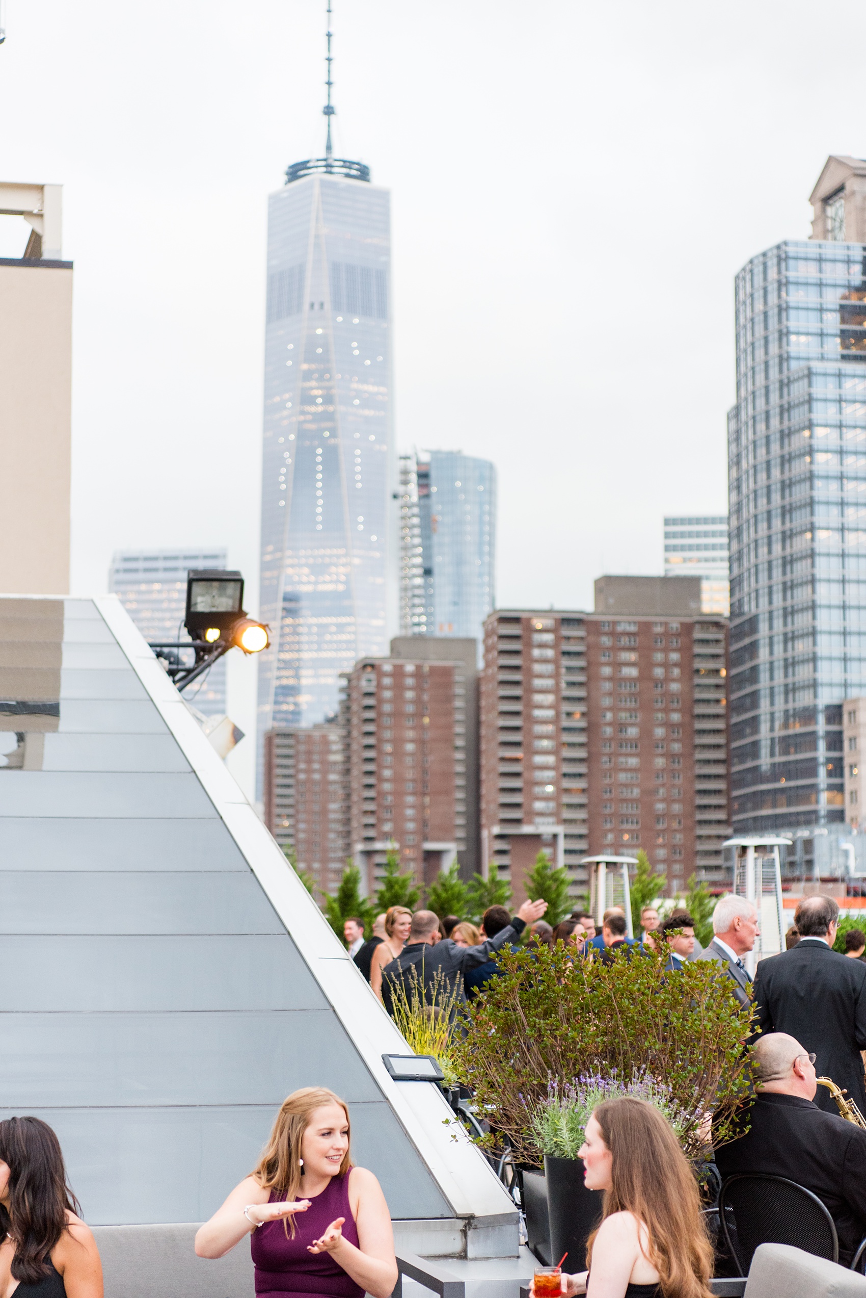 Photos of a NYC wedding venue, Tribeca Rooftop, by Mikkel Paige Photography. This ceremony and reception location has an outdoor space overlooking the Manhattan skyline. These pictures will provide inspiration in New York! The couple dreamed of getting married in this awesome city with flowers and colors of fall. Click through for more details from this beautiful celebration! #TribecaRooftop #NYCVenues #MikkelPaige #NYCwedding #NYCskyline #NYCWeddingPhotos #NYCWeddingPhotography #cocktailhour