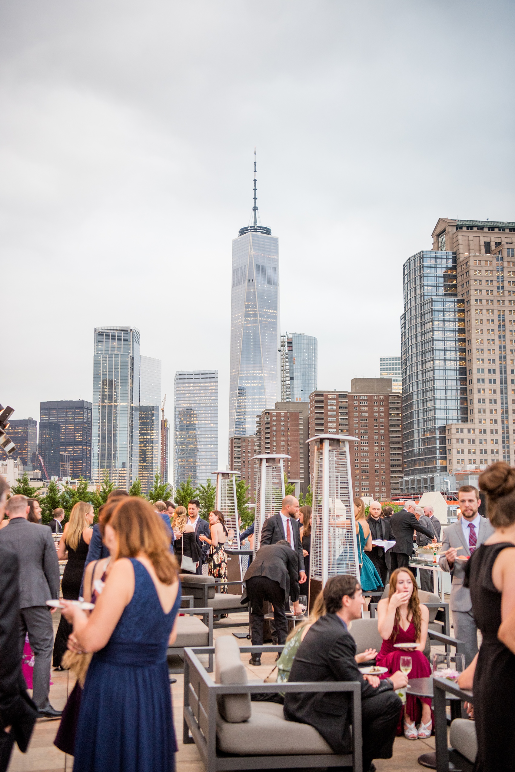 Photos of a NYC wedding venue, Tribeca Rooftop, by Mikkel Paige Photography. This ceremony and reception location has an outdoor space overlooking the Manhattan skyline. These pictures will provide inspiration in New York! The couple dreamed of getting married in this awesome city with flowers and colors of fall. Click through for more details from this beautiful celebration! #TribecaRooftop #NYCVenues #MikkelPaige #NYCwedding #NYCskyline #NYCWeddingPhotos #NYCWeddingPhotography #cocktailhour