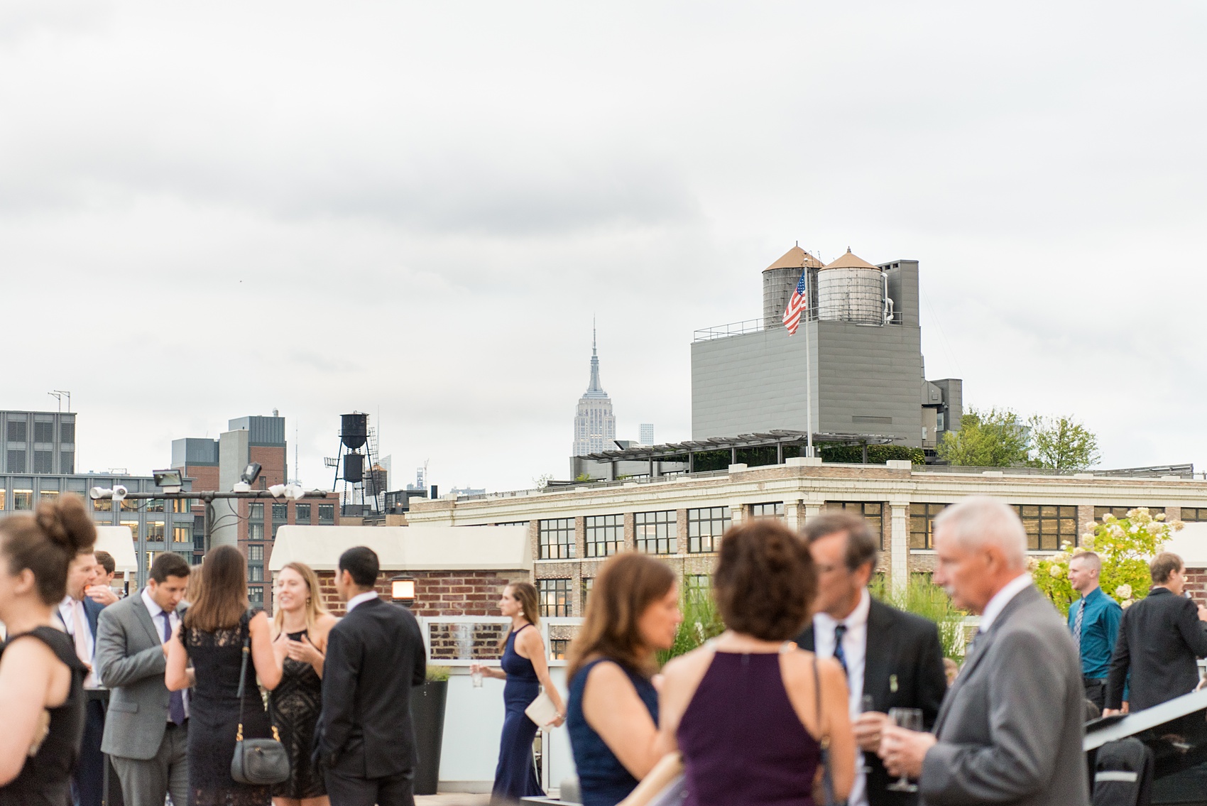 Photos of a NYC wedding venue, Tribeca Rooftop, by Mikkel Paige Photography. This ceremony and reception location has an outdoor space overlooking the Manhattan skyline. These pictures will provide inspiration in New York! The couple dreamed of getting married in this awesome city with flowers and colors of fall. Click through for more details from this beautiful celebration! #TribecaRooftop #NYCVenues #MikkelPaige #NYCwedding #NYCskyline #NYCWeddingPhotos #NYCWeddingPhotography #cocktailhour