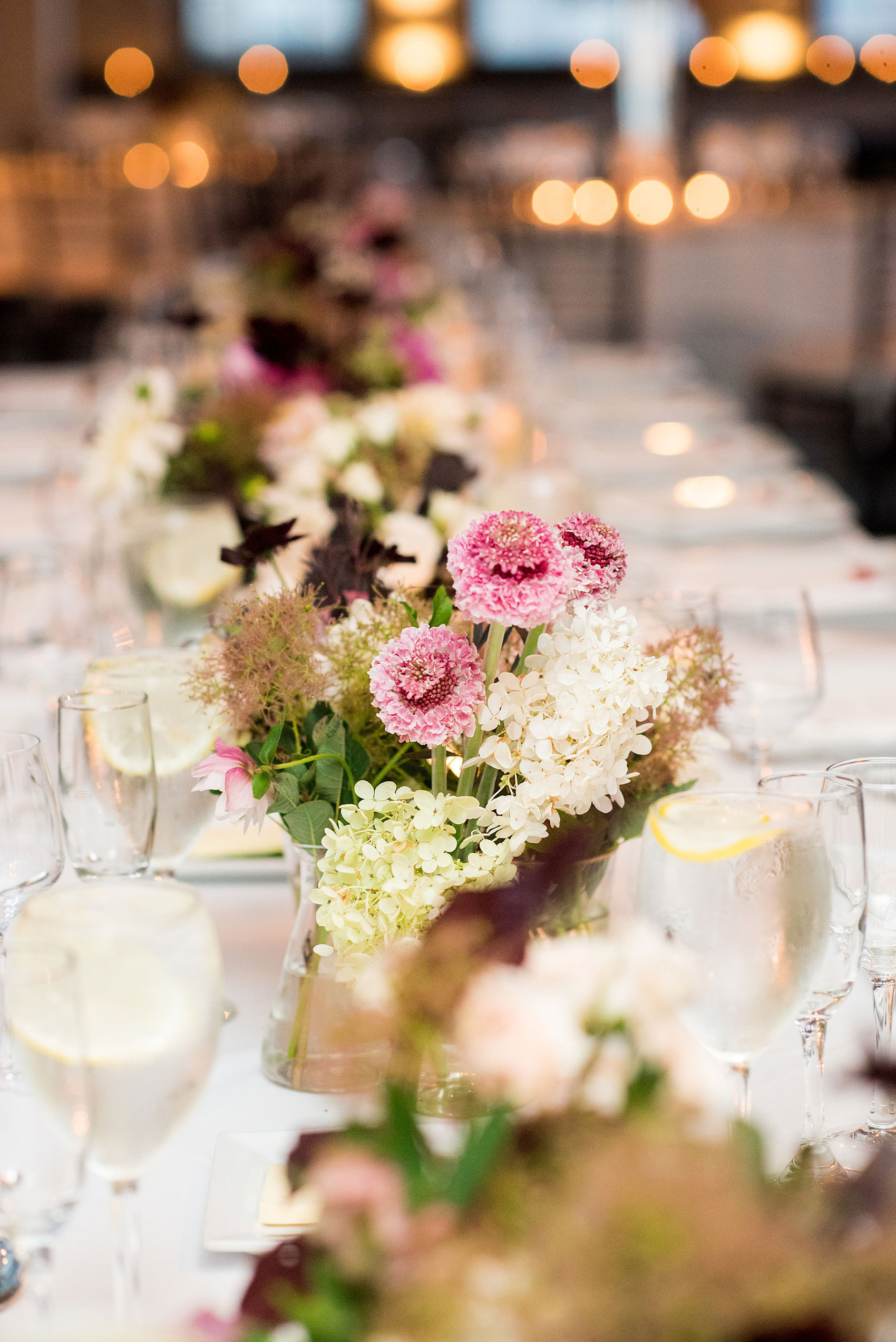 Photos of a NYC wedding venue, Tribeca Rooftop, by Mikkel Paige Photography. This ceremony and reception location has an outdoor space overlooking the Manhattan skyline. These pictures will provide inspiration in New York! The couple dreamed of getting married in this awesome city with flowers and colors of fall. Click through for more details from this beautiful celebration! #TribecaRooftop #NYCVenues #MikkelPaige #NYCwedding #fallflowers 