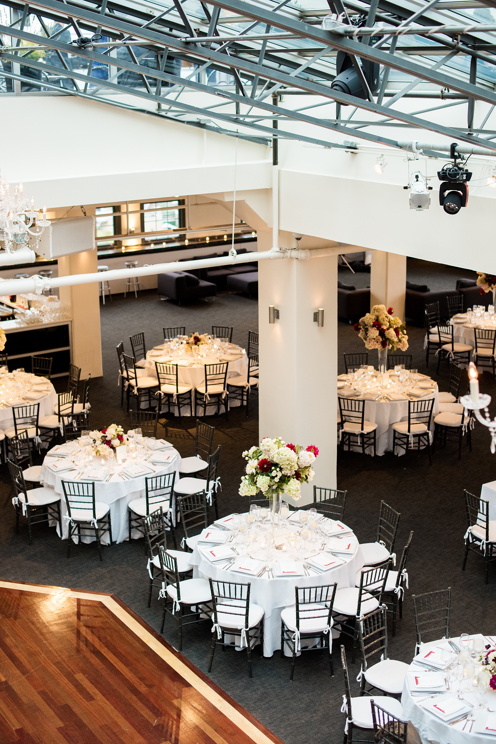 Photos of a NYC wedding venue, Tribeca Rooftop, by Mikkel Paige Photography. This ceremony and reception location has an outdoor space overlooking the Manhattan skyline. These pictures will provide inspiration in New York! The couple dreamed of getting married in this awesome city with flowers and colors of fall. Click through for more details from this beautiful celebration! #TribecaRooftop #NYCVenues #MikkelPaige #NYCwedding #fallflowers 