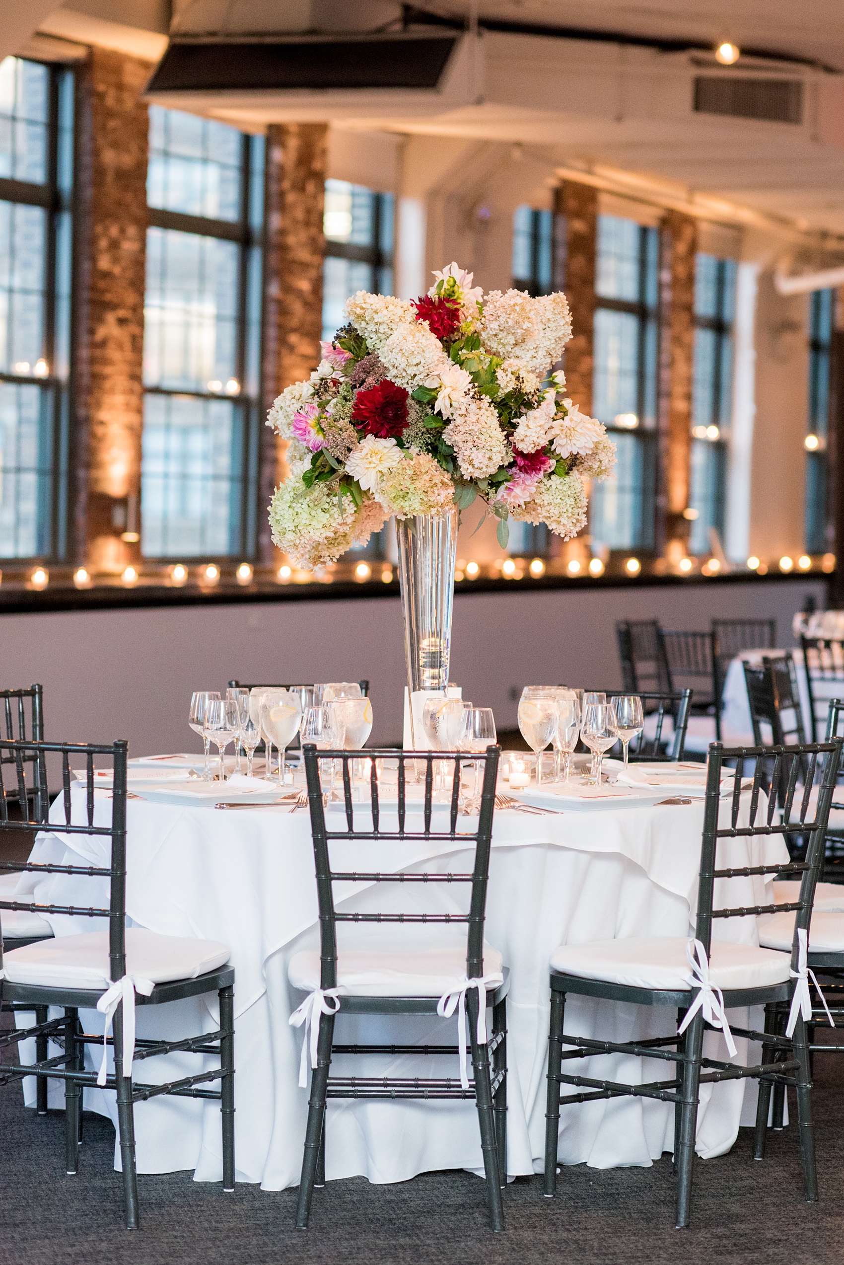 Photos of a NYC wedding venue, Tribeca Rooftop, by Mikkel Paige Photography. This ceremony and reception location has an outdoor space overlooking the Manhattan skyline. These pictures will provide inspiration in New York! The couple dreamed of getting married in this awesome city with flowers and colors of fall. Click through for more details from this beautiful celebration! #TribecaRooftop #NYCVenues #MikkelPaige #NYCwedding #fallflowers 