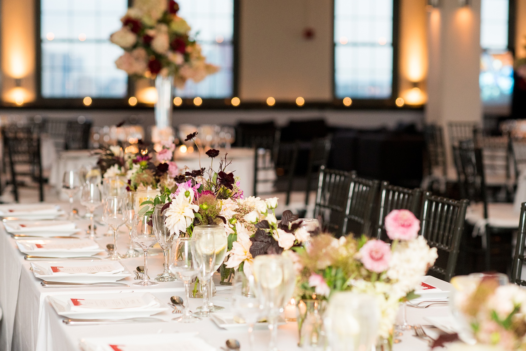 Photos of a NYC wedding venue, Tribeca Rooftop, by Mikkel Paige Photography. This ceremony and reception location has an outdoor space overlooking the Manhattan skyline. These pictures will provide inspiration in New York! The couple dreamed of getting married in this awesome city with flowers and colors of fall. Click through for more details from this beautiful celebration! #TribecaRooftop #NYCVenues #MikkelPaige #NYCwedding #NYCskyline #NYCWeddingPhotos #NYCWeddingPhotography 