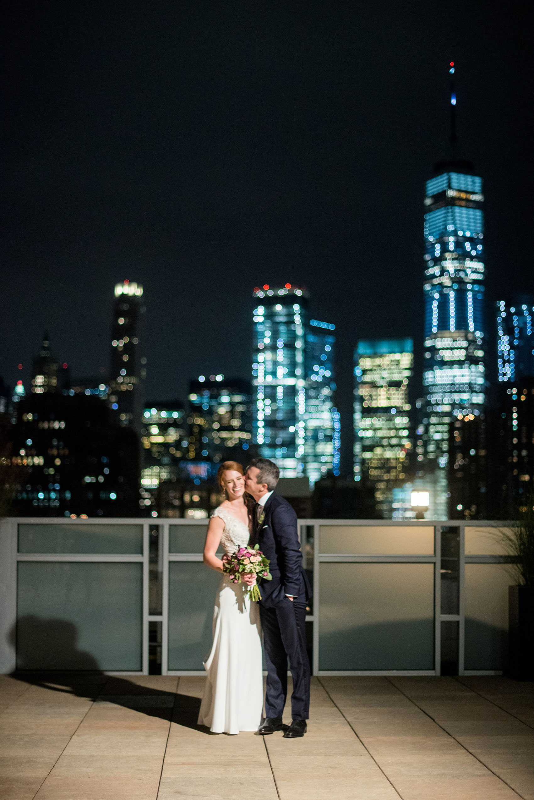 Photos of a NYC wedding venue, Tribeca Rooftop, by Mikkel Paige Photography. This ceremony and reception location has an outdoor space overlooking the Manhattan skyline. These pictures will provide inspiration in New York! The couple dreamed of getting married in this awesome city with flowers and colors of fall. Click through for more details from this beautiful celebration! #TribecaRooftop #NYCVenues #MikkelPaige #NYCwedding #NYCskyline #rooftopweddingphotos 