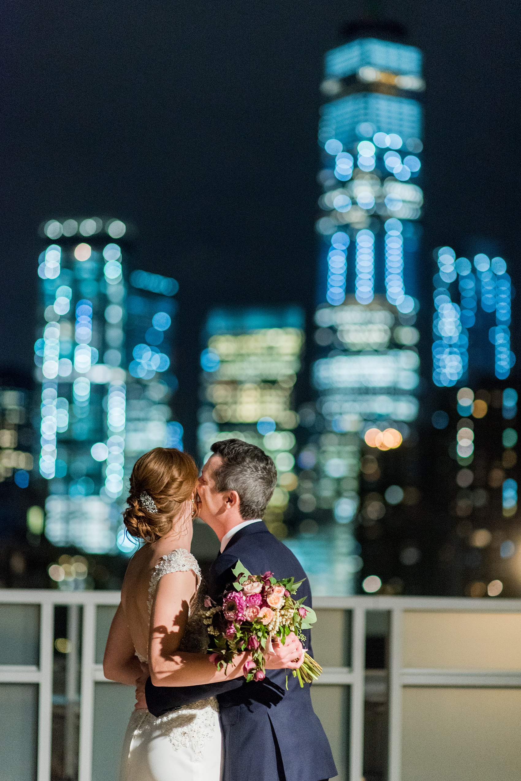 Photos of a NYC wedding venue, Tribeca Rooftop, by Mikkel Paige Photography. This ceremony and reception location has an outdoor space overlooking the Manhattan skyline. These pictures will provide inspiration in New York! The couple dreamed of getting married in this awesome city with flowers and colors of fall. Click through for more details from this beautiful celebration! #TribecaRooftop #NYCVenues #MikkelPaige #NYCwedding #NYCskyline #rooftopweddingphotos 