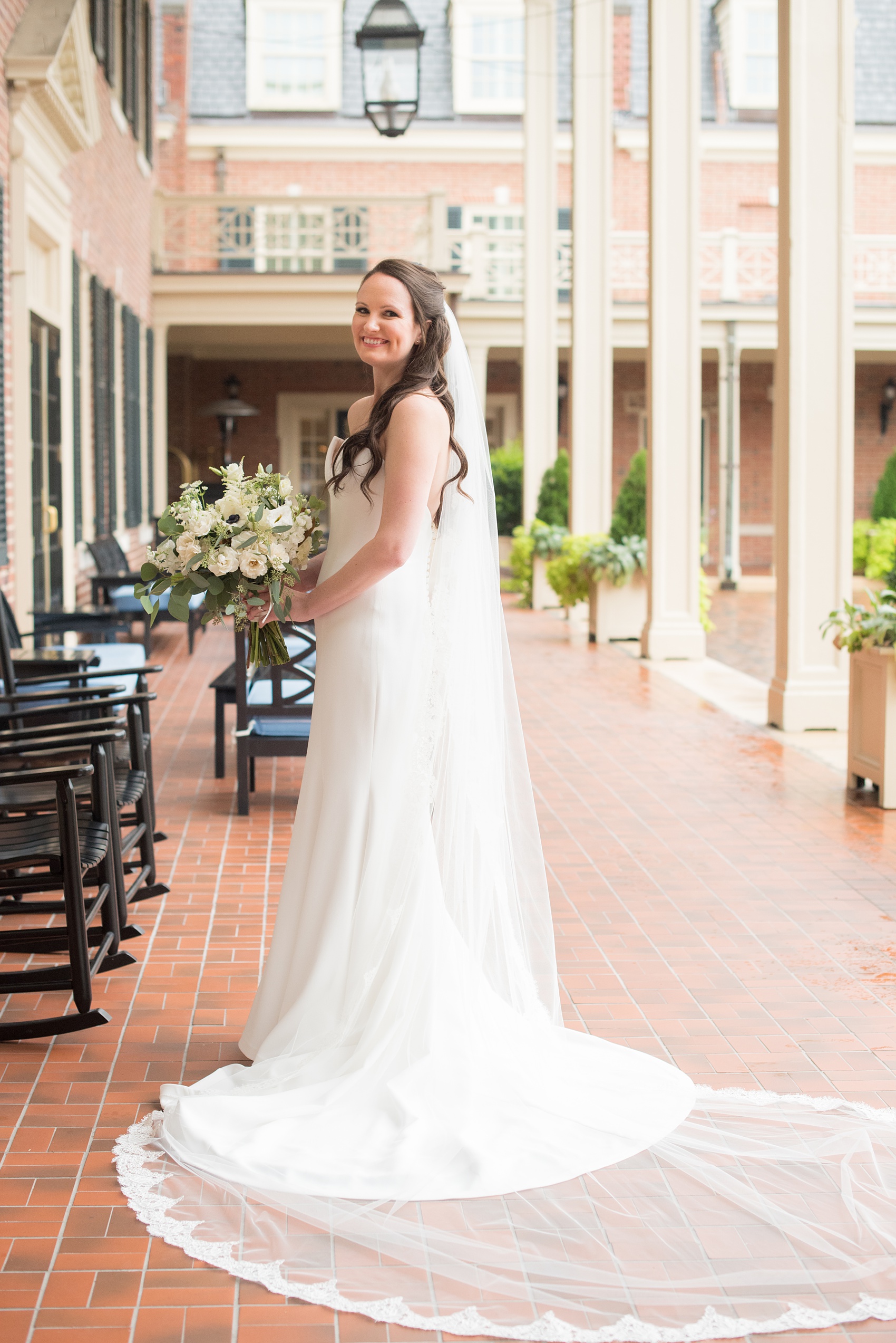 Photos of a fall wedding at The Carolina Inn, in Chapel Hill North Carolina, by Mikkel Paige Photography. This event venue doubles as a hotel for guests, who can enjoy a reception and ceremony indoors or outdoors. The bride wore a beautiful, simple white gown with a v-neck cut out and a cathedral length veil. Click through to see inspiration from the entire wedding! Planner: @asouthernsoiree #thecarolinainn #ChapelHillWeddings #MikkelPaige #ASouthernSoiree #bride #bridestyle #simpleweddinggown