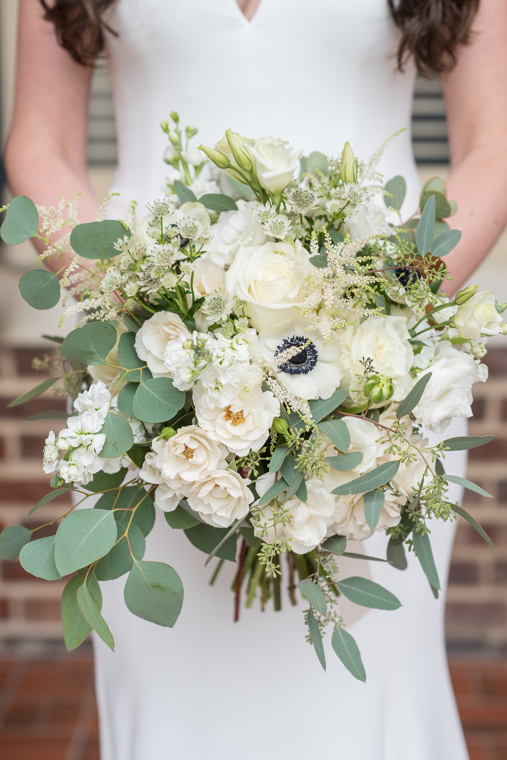 Photos of a fall wedding at The Carolina Inn, in Chapel Hill North Carolina, by Mikkel Paige Photography. This event venue doubles as a hotel for guests, who can enjoy a reception indoors or outdoors. The bride’s bouquet was white with eucalyptus greenery, including lisanthus, anemones with purple centers, and roses by The Flower Cupboard. Click through to see inspiration from the entire wedding! Planner: @asouthernsoiree #thecarolinainn #ChapelHillWeddings #MikkelPaige #bridalbouquet