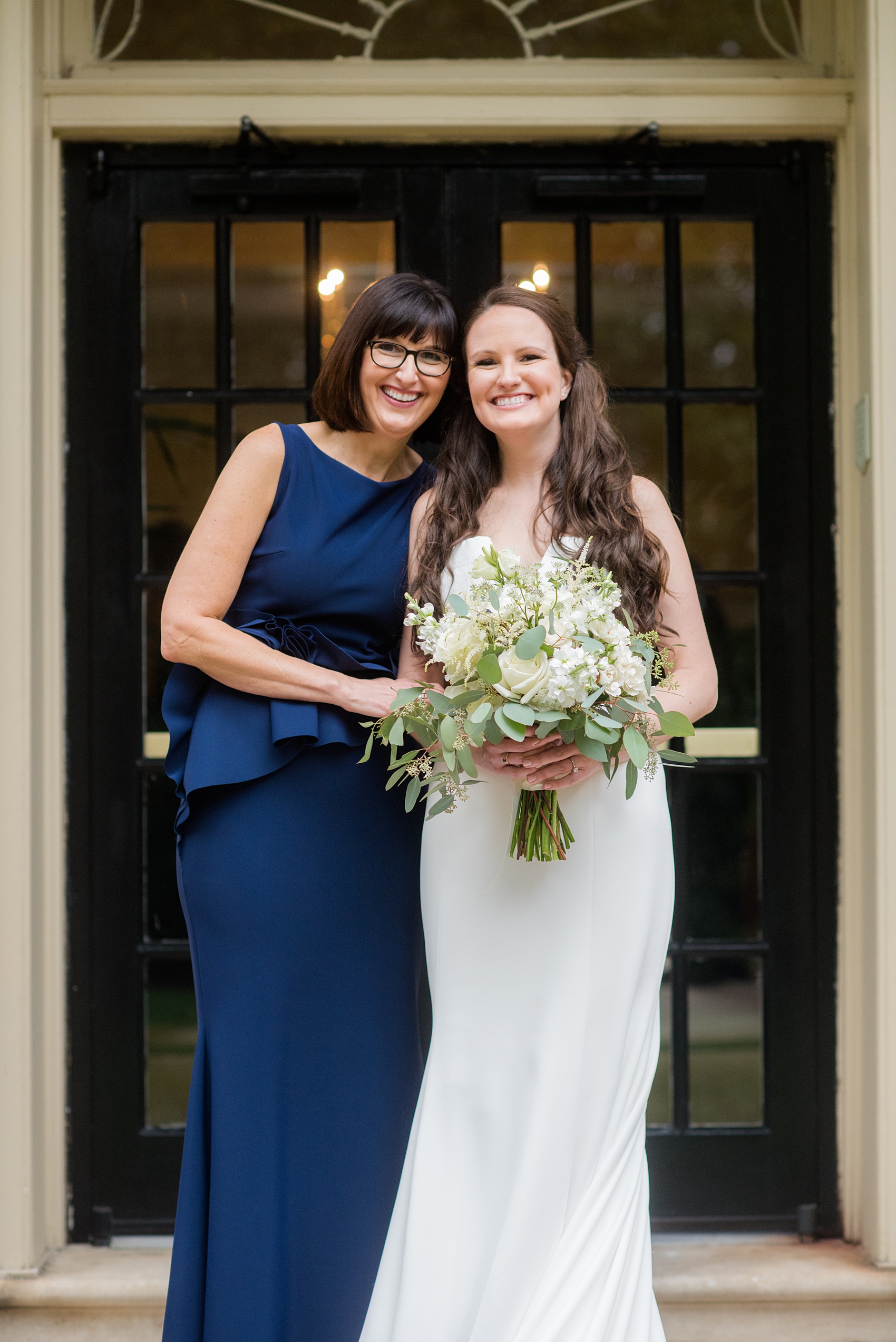 Photos of a fall wedding at The Carolina Inn, in Chapel Hill North Carolina, by Mikkel Paige Photography. This event venue doubles as a hotel for guests, who can enjoy a reception and ceremony indoors or outdoors. The bride’s mother stood by her beautiful daughter, a bride wearing a simple elegant white gown and cathedral length veil. Click through to see inspiration from the entire wedding! Planner: @asouthernsoiree #thecarolinainn #ChapelHillWeddings #MikkelPaige #bride #motherofthebride