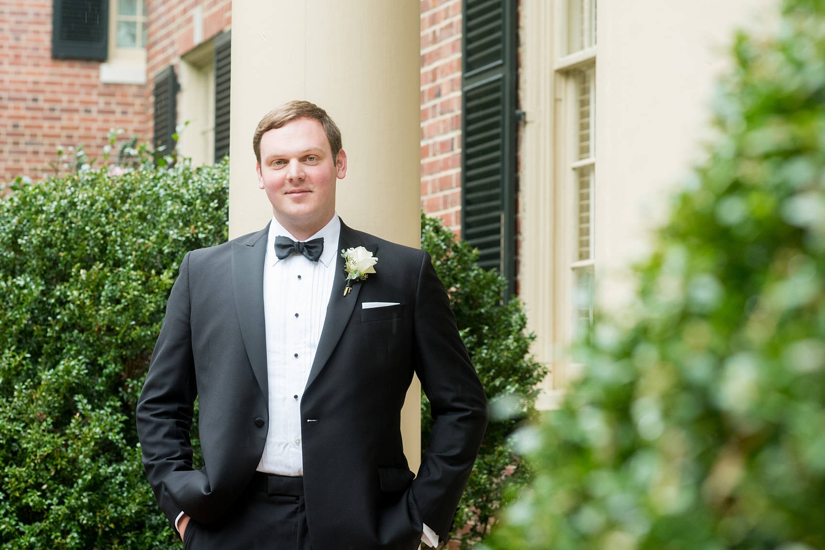 Photos of a fall wedding at The Carolina Inn, in Chapel Hill North Carolina, by Mikkel Paige Photography. This event venue doubles as a hotel for guests, who can enjoy a reception indoors or outdoors. The groomsmen wore classic black tuxedos with white rose boutonnieres by The Flower Cupboard. Click through to see inspiration from the entire wedding! Planner: @asouthernsoiree #thecarolinainn #ChapelHillWeddings #MikkelPaige #ASouthernSoiree #greenwedding #groomsmen #blacktuxedos