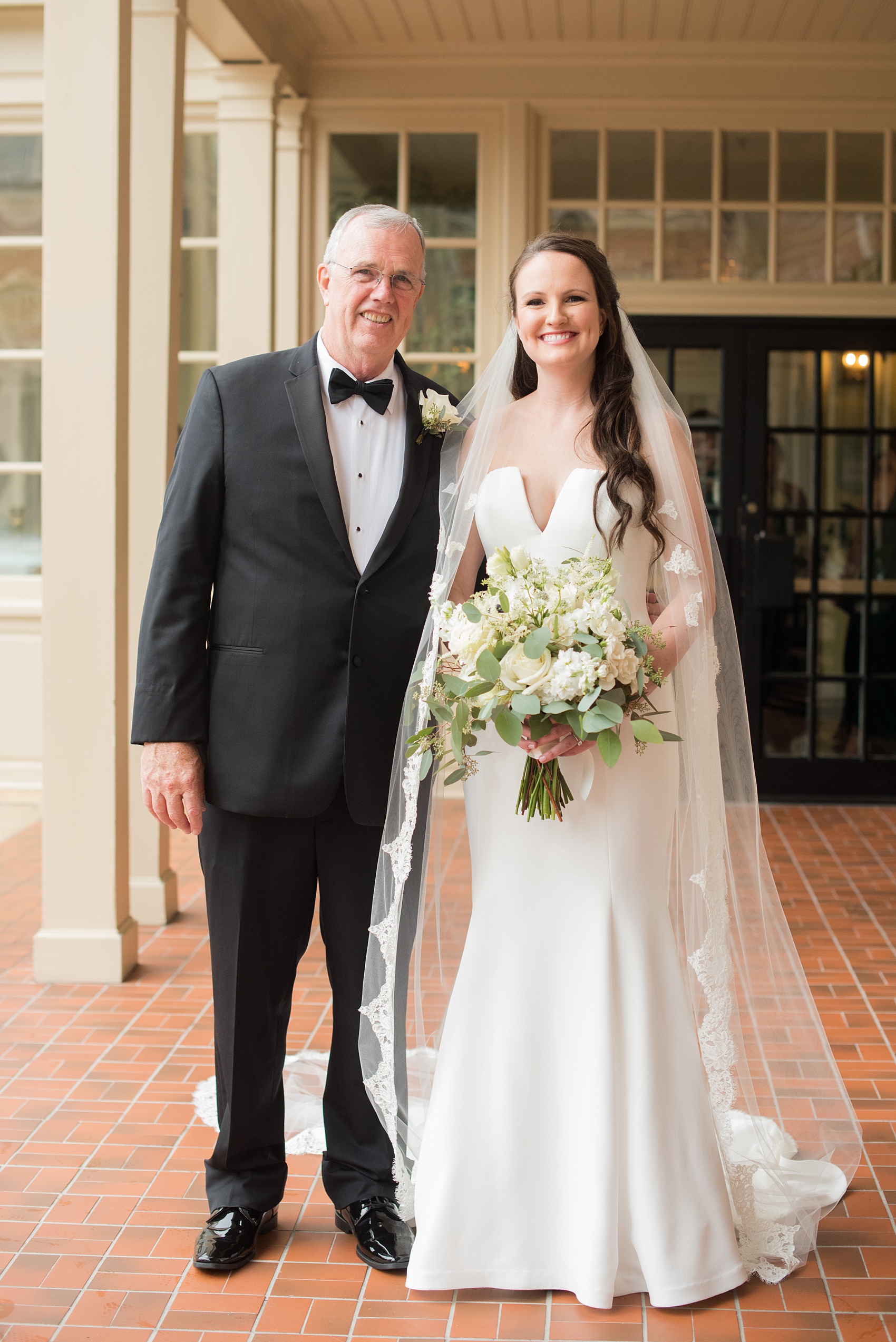 Photos of a fall wedding at The Carolina Inn, in Chapel Hill North Carolina, by Mikkel Paige Photography. This event venue doubles as a hotel for guests, who can enjoy a reception and ceremony indoors or outdoors. The bride’s father was shocked by his beautiful daughter, a bride wearing a simple elegant white gown and cathedral length veil. Click through to see inspiration from the entire wedding! Planner: @asouthernsoiree #thecarolinainn #ChapelHillWeddings #MikkelPaige #bride #fatherofthebride