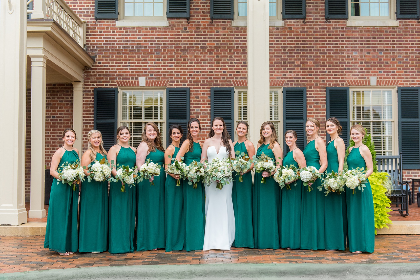 Wedding Party Photos of a fall wedding at The Carolina Inn, in Chapel Hill North Carolina, by Mikkel Paige Photography. This event venue doubles as a hotel for guests, who can enjoy a reception indoors or outdoors. The bridesmaids wore long green gowns and carried white bouquets with eucalyptus greenery. Click through to see inspiration from the entire wedding! Planner: @asouthernsoiree, Flowers by The Flower Cupboard #thecarolinainn #ChapelHillWeddings #MikkelPaige #ASouthernSoiree #greenbridesmaids #greenwedding #bridalparty